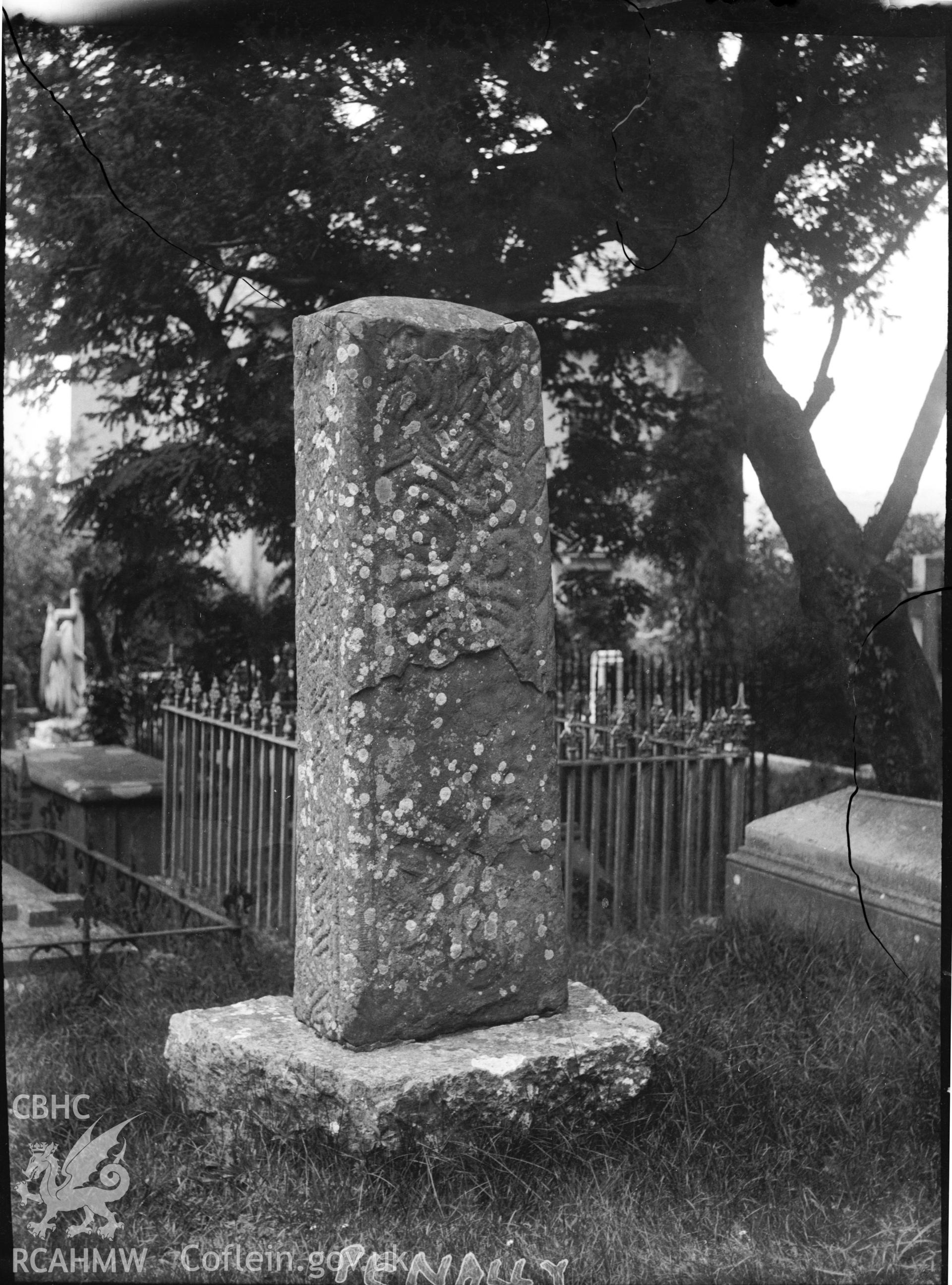 Black and white photo showing inscribed stone in Penally Churchyard.