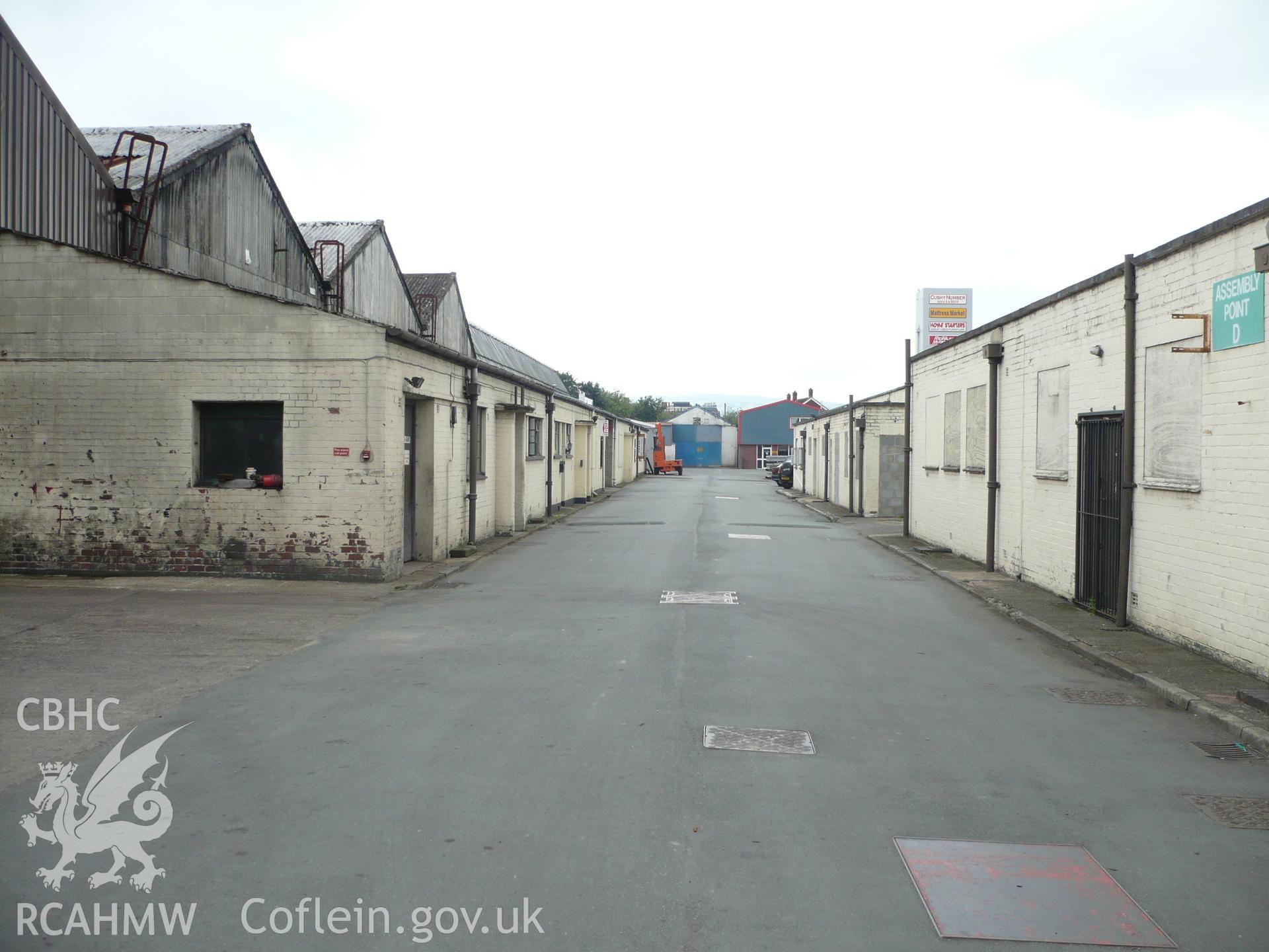 View from the northeast along the roadway between the office block to the right and the main production hall to the left