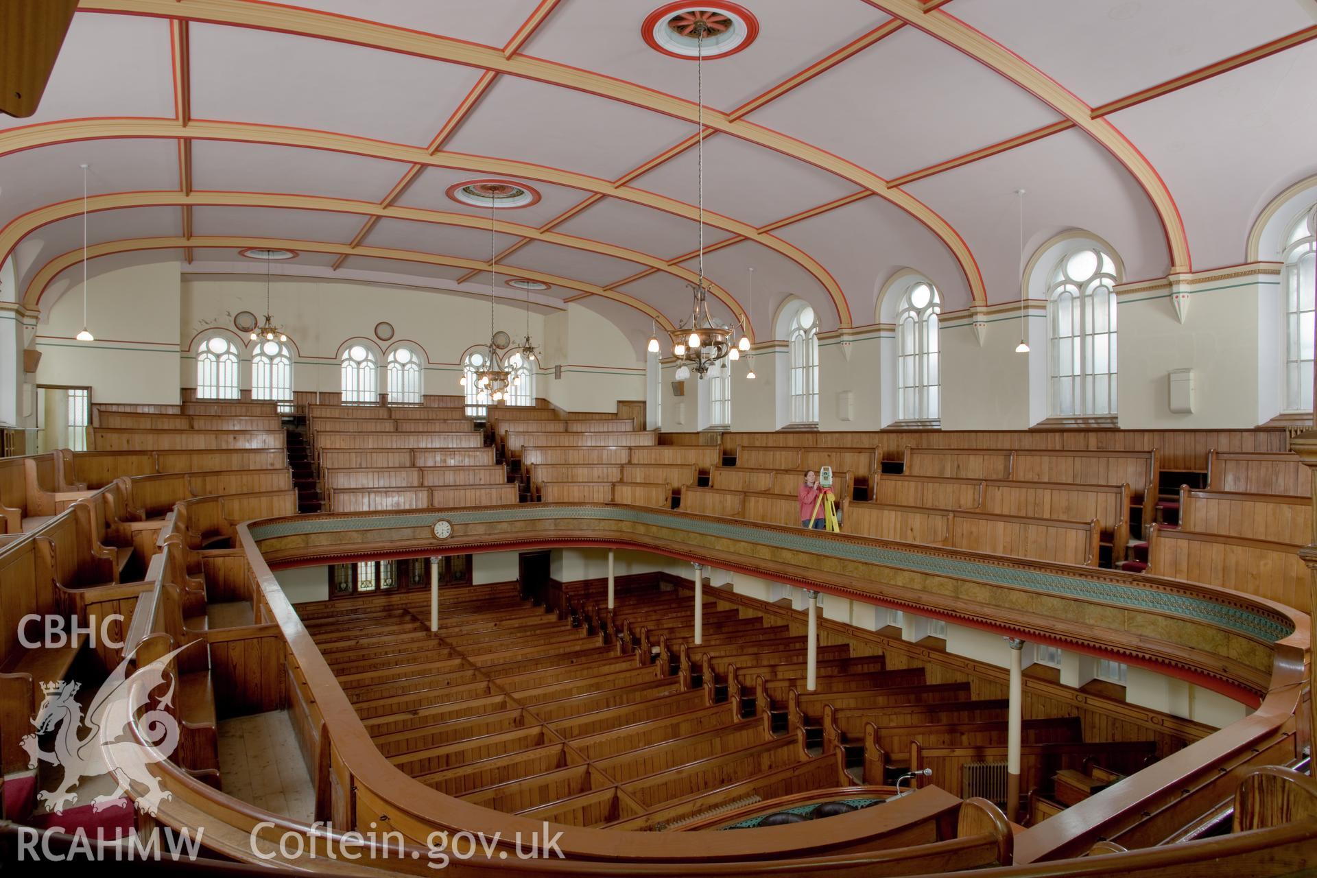 Susan Fielding carrying out Total Station survey inside chapel.