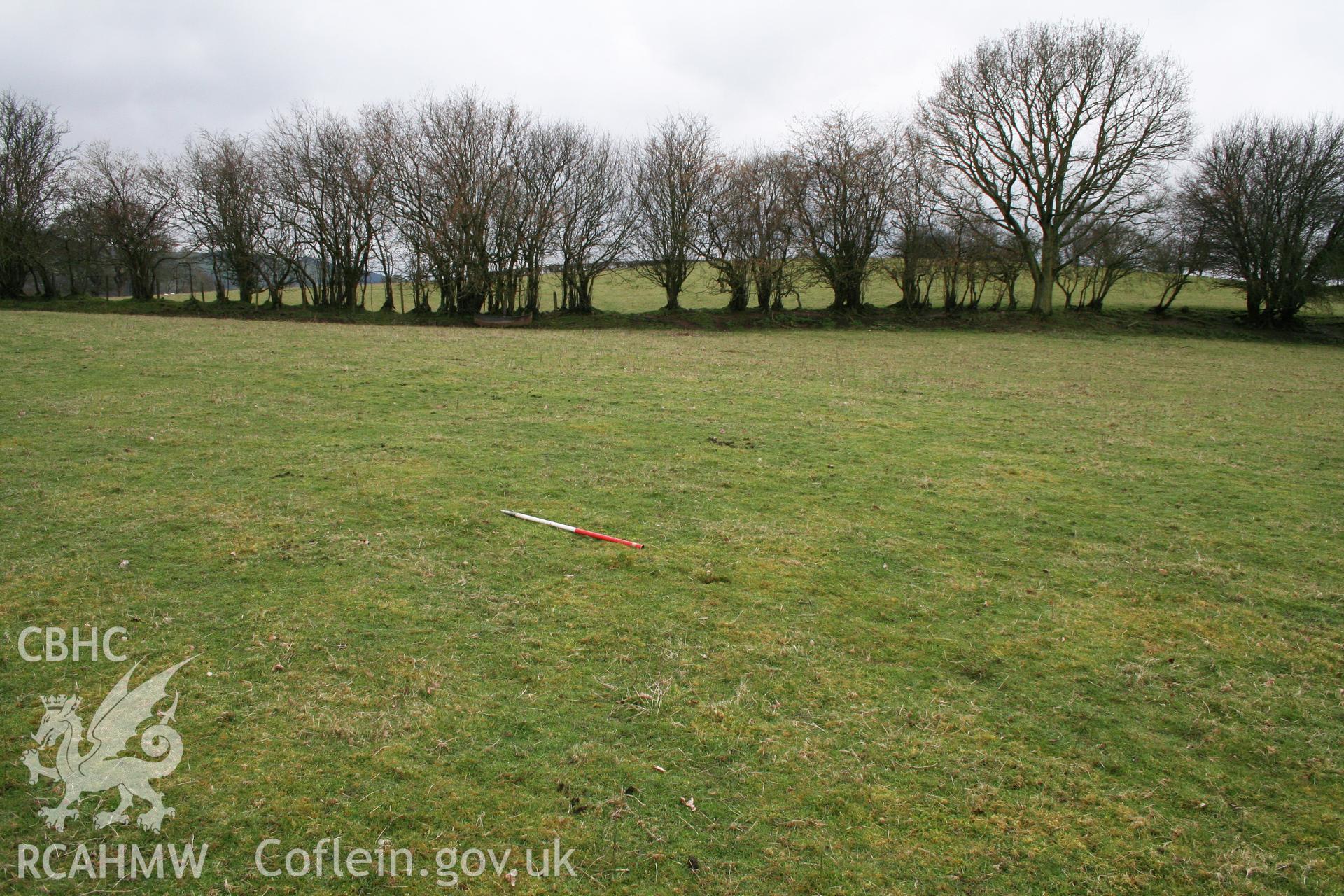 View of plough-levelled barrows (site of) from east, showing possible slight earthwork, 1m scale