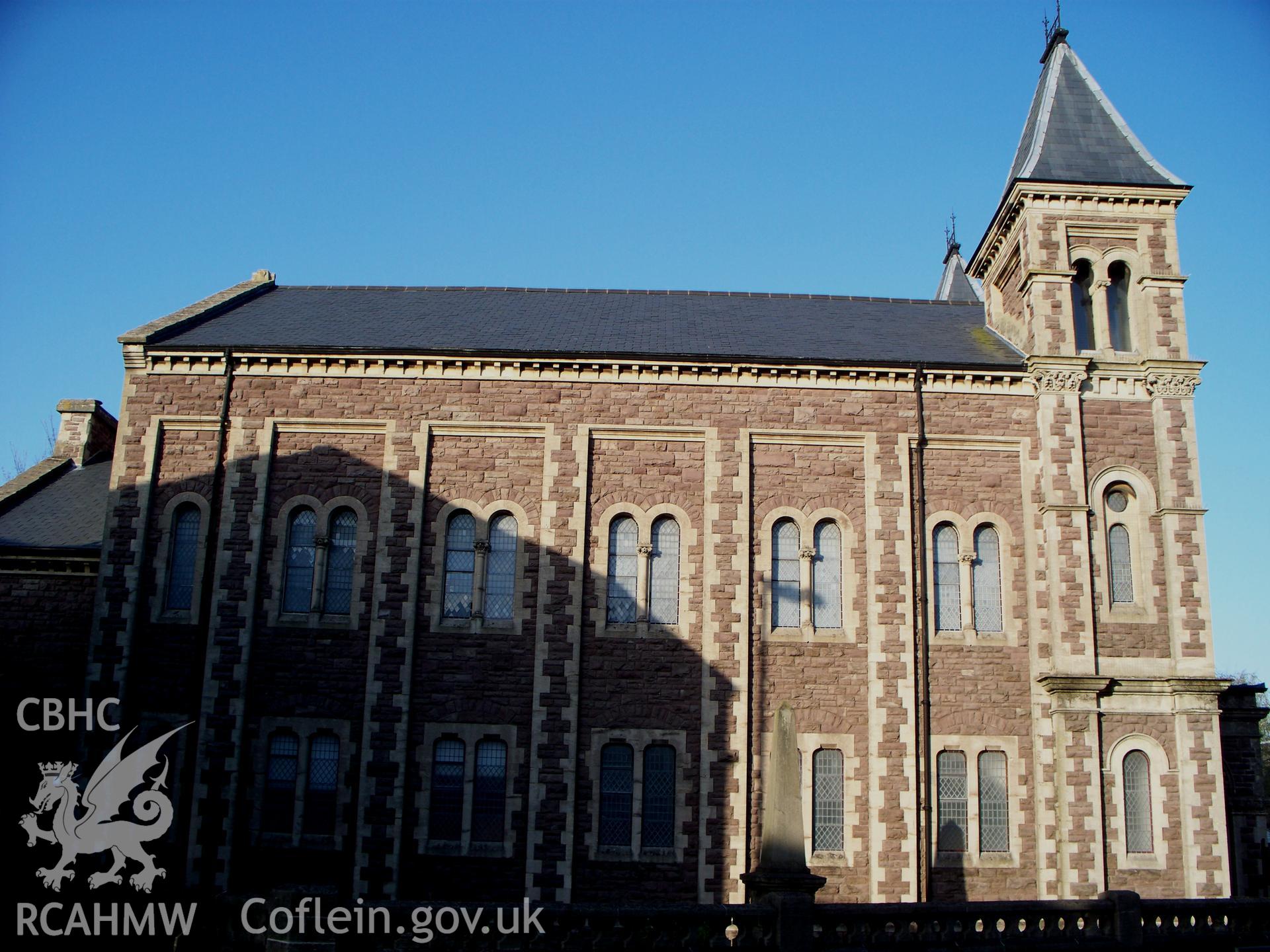 General view of the south-west side of the chapel showing tower and spire