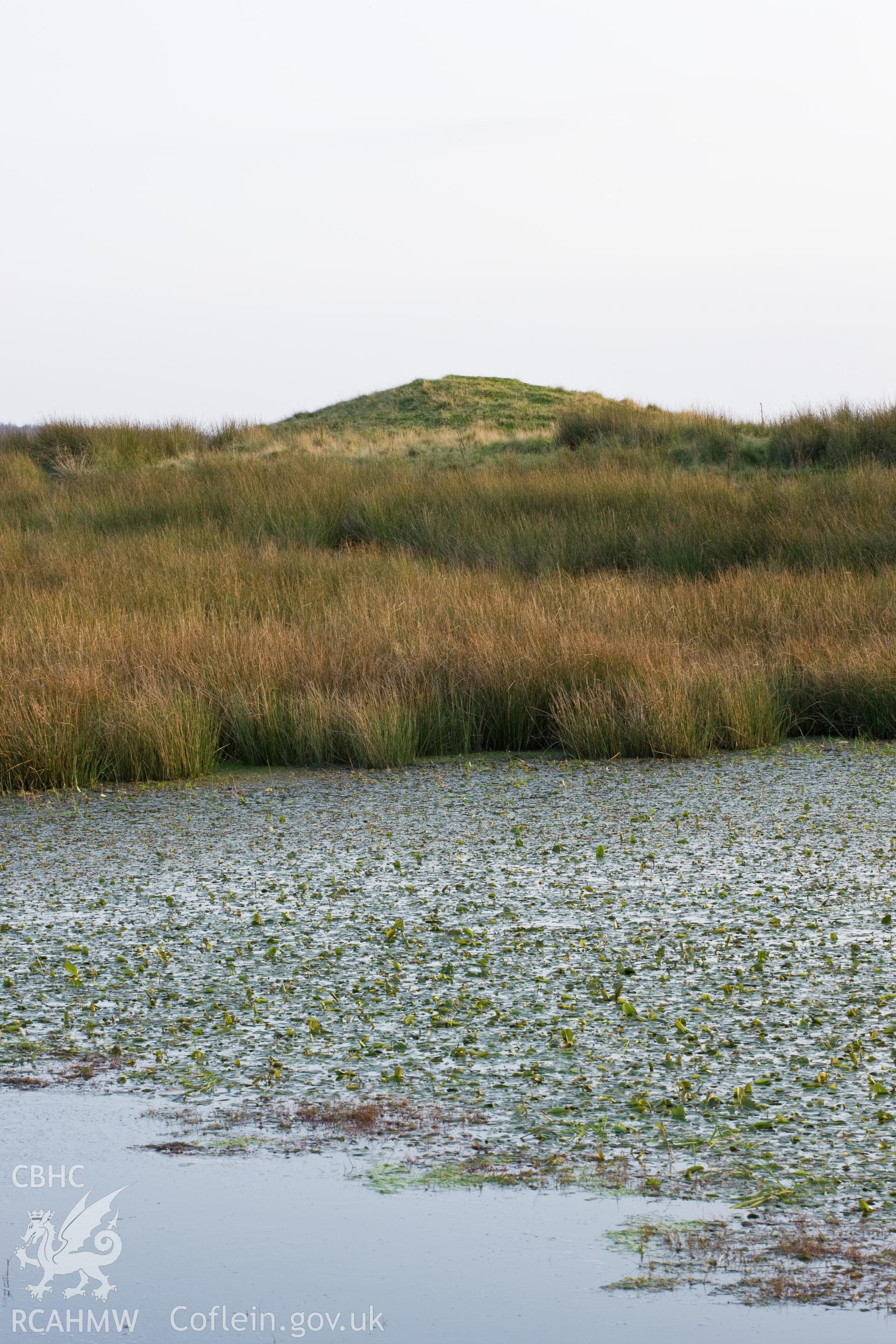 View from the north with water in the foreground. Vertical.