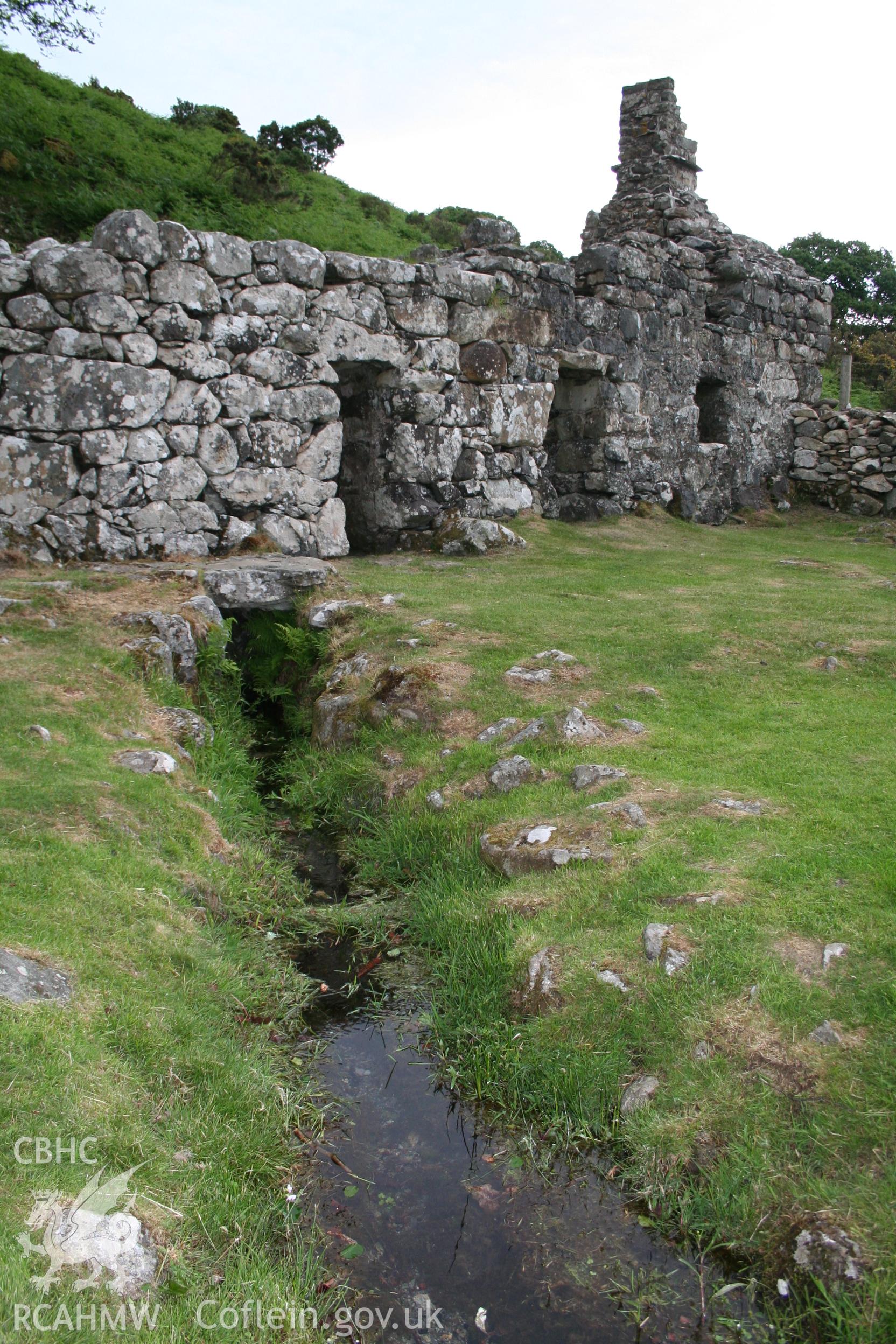 View towards well house and cottage from latrine building.