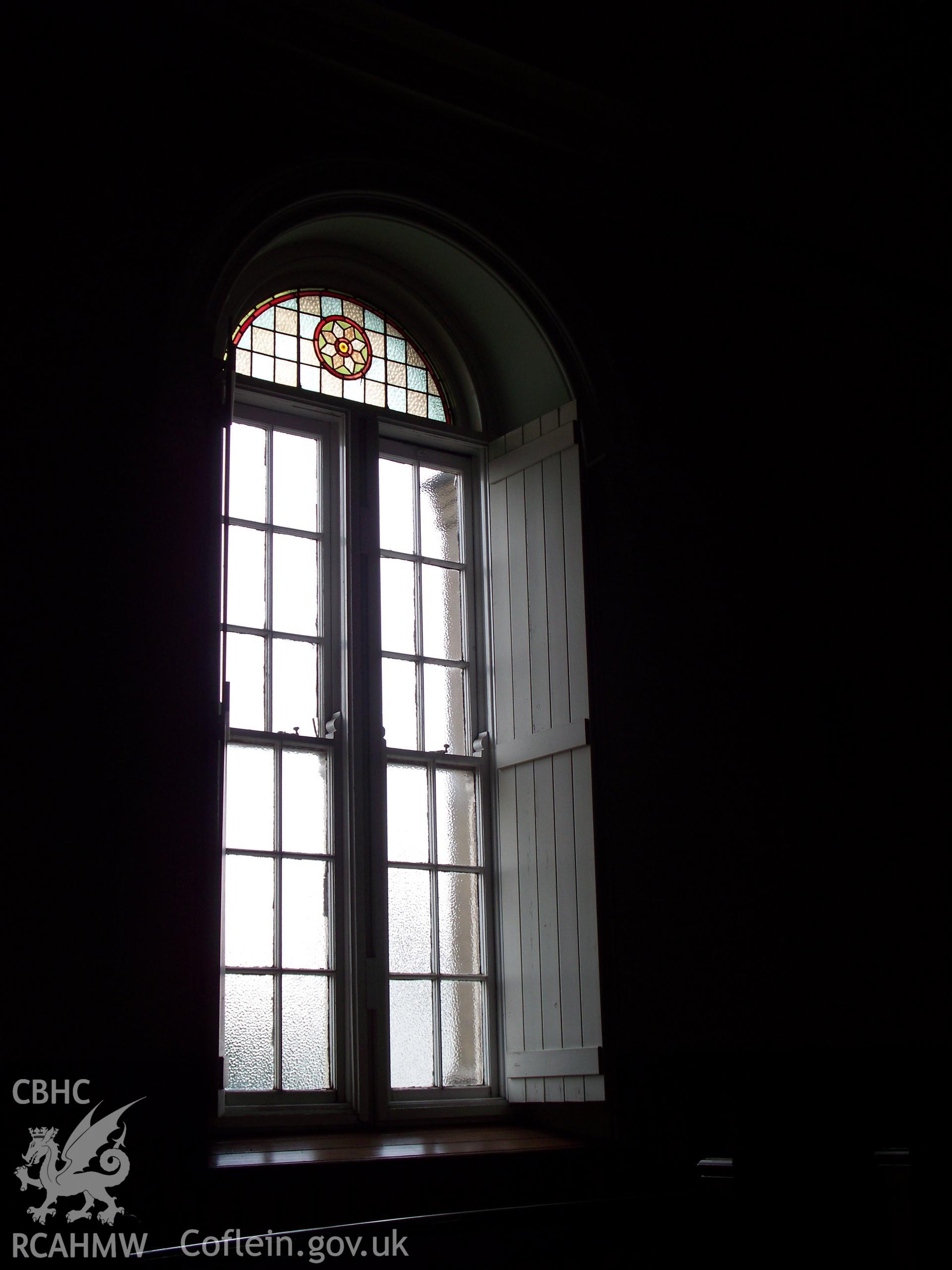 Detail of typical side window showing stained-glass top & shutters.