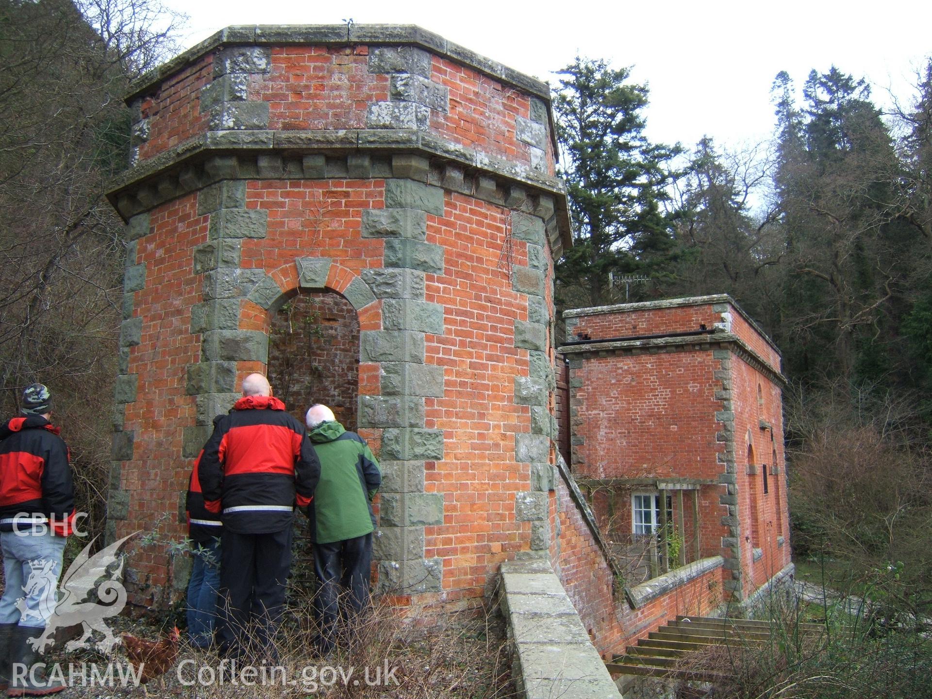 Octagonal turret from NW with cable tunnel & water-turbine house/lower funicular station beyond with David Percival & TV producer Richard Edwards (right) peering down haulage cable shaft.