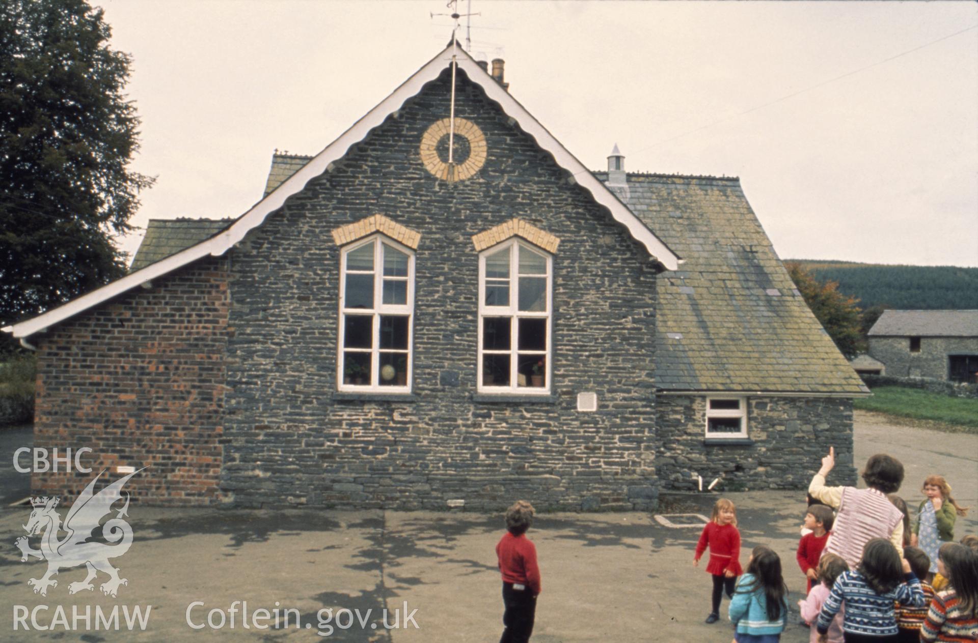 Colour photographic transparency showing Llangybi school, Ceredigion, with children playing; collated by the former Central Office of Information.