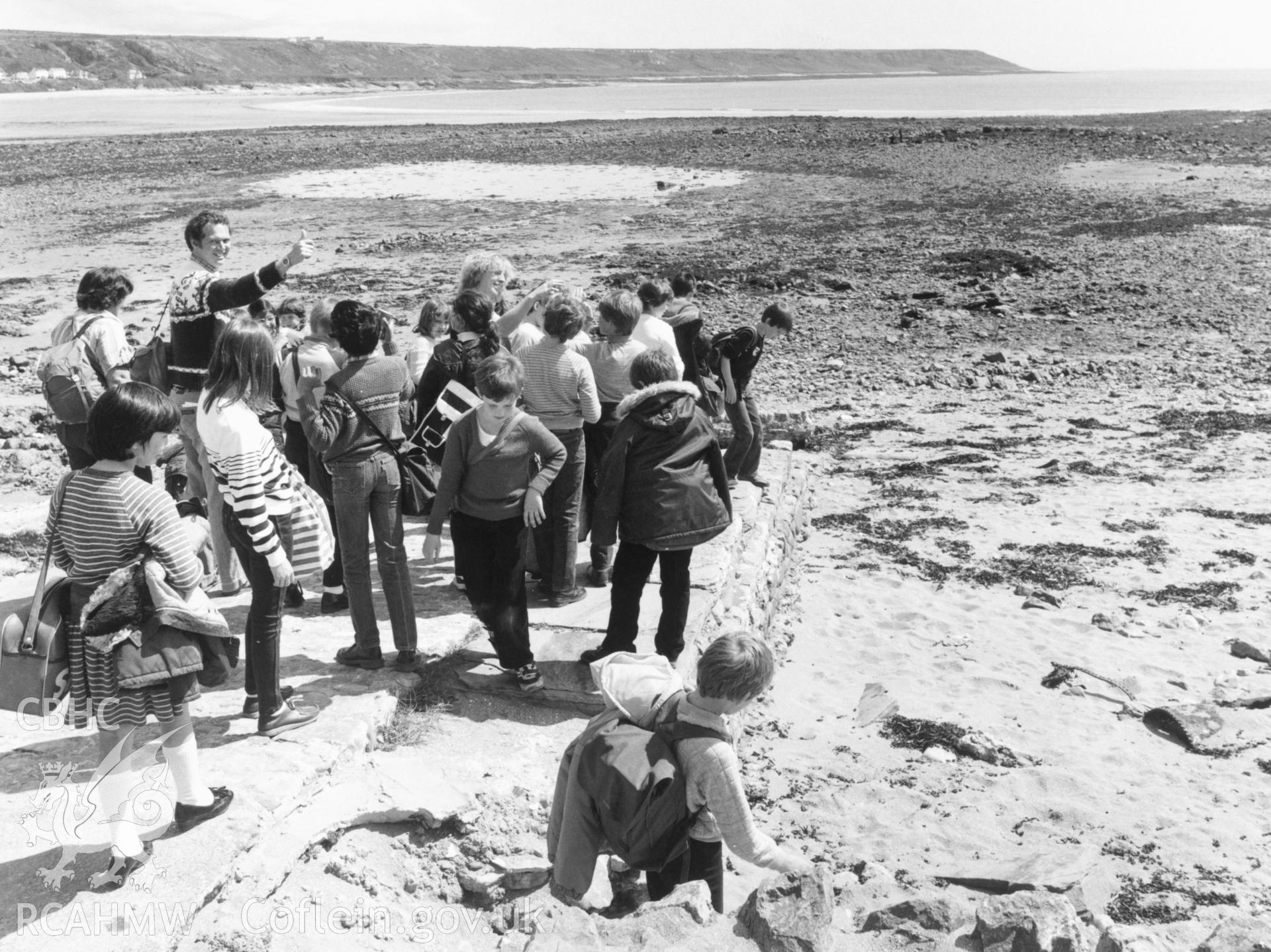 1 b/w print showing view of Oystermouth beach with group of children; collated by the former Central Office of Information.