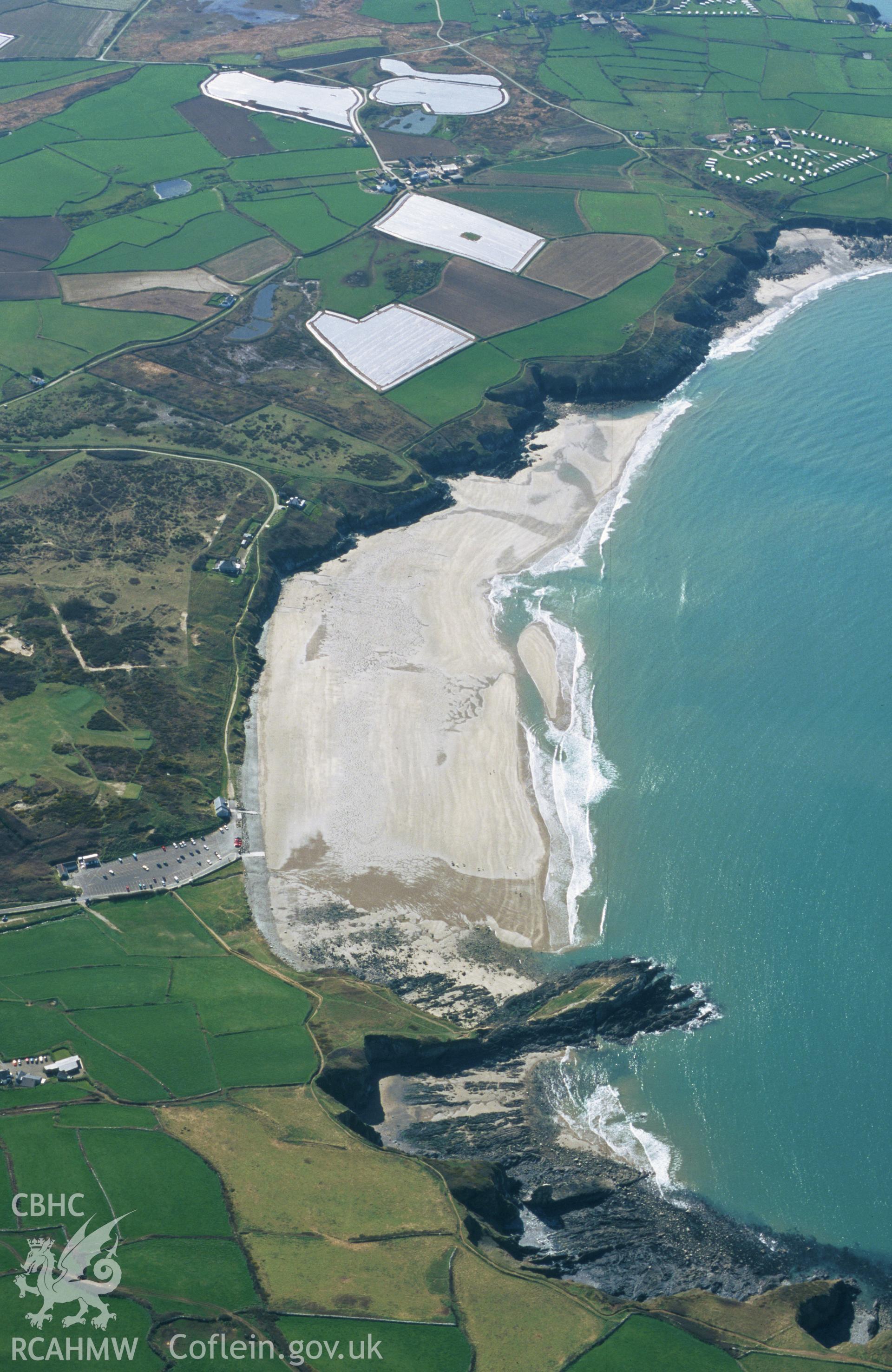 Slide of RCAHMW colour oblique aerial photograph of aerial view of St Patrick's Chapel, Whitesands Bay, taken by Toby Driver, 2002.