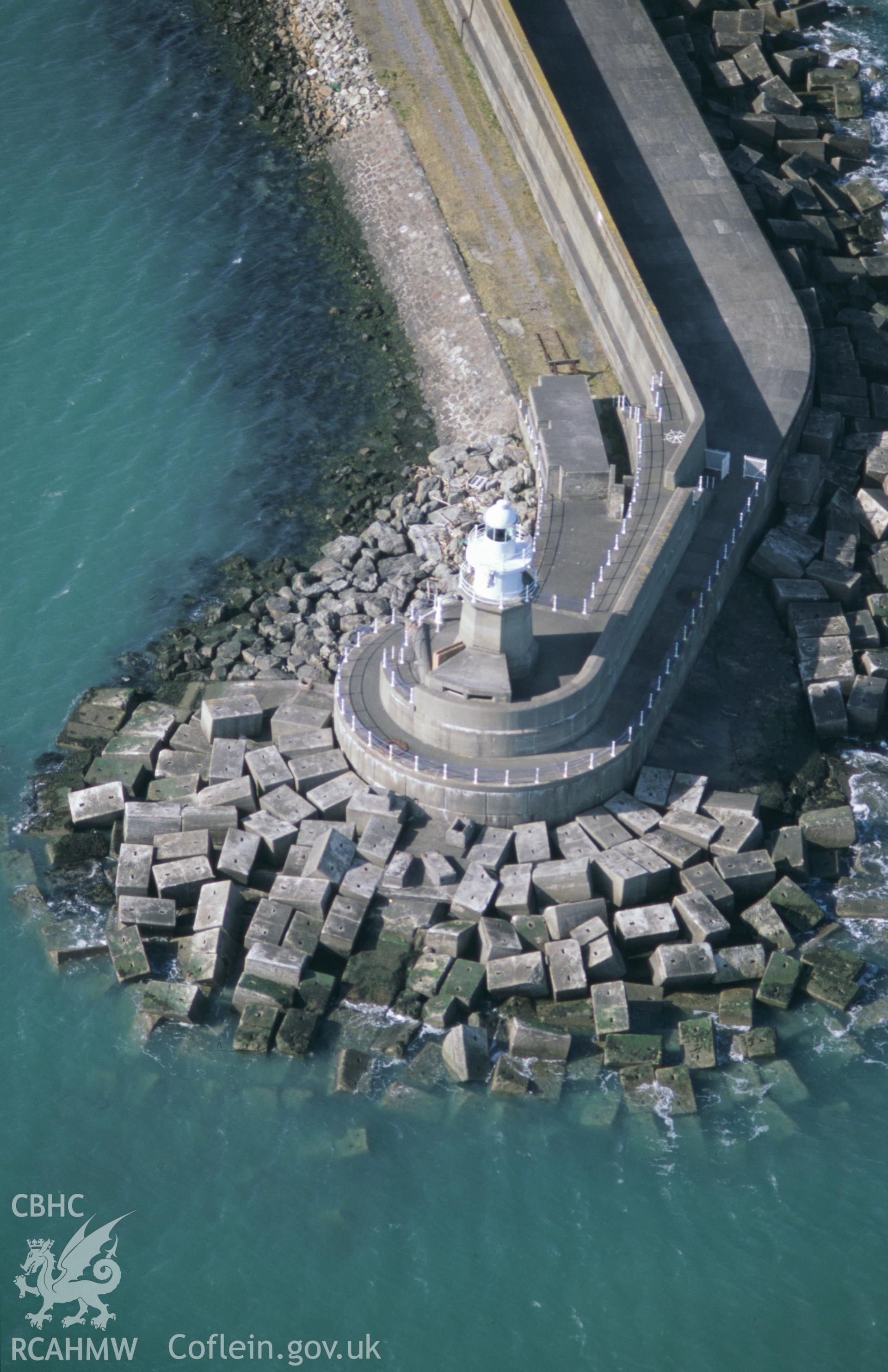 Slide of RCAHMW colour oblique aerial photograph of north breakwater anf lighthouse at Goodwick, taken by T.G. Driver, 5/3/2002.