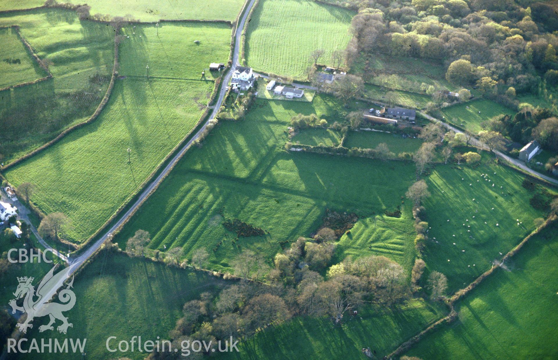 Slide of RCAHMW colour oblique aerial photograph of earthworks at Landshipping House, Martletwy, taken by C.R. Musson, 19/4/1995.