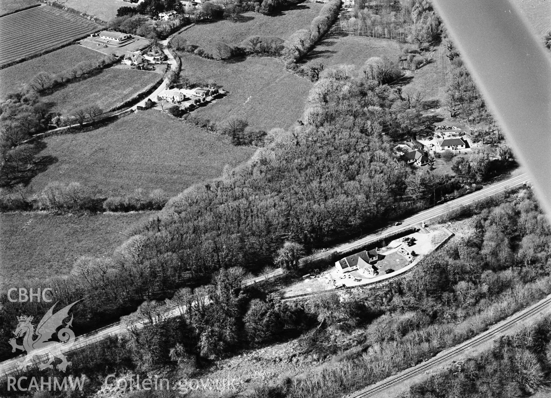 RCAHMW black and white aerial photograph of Pant Lladron, enclosure, wooded. Taken by Toby Driver on 10/04/2003