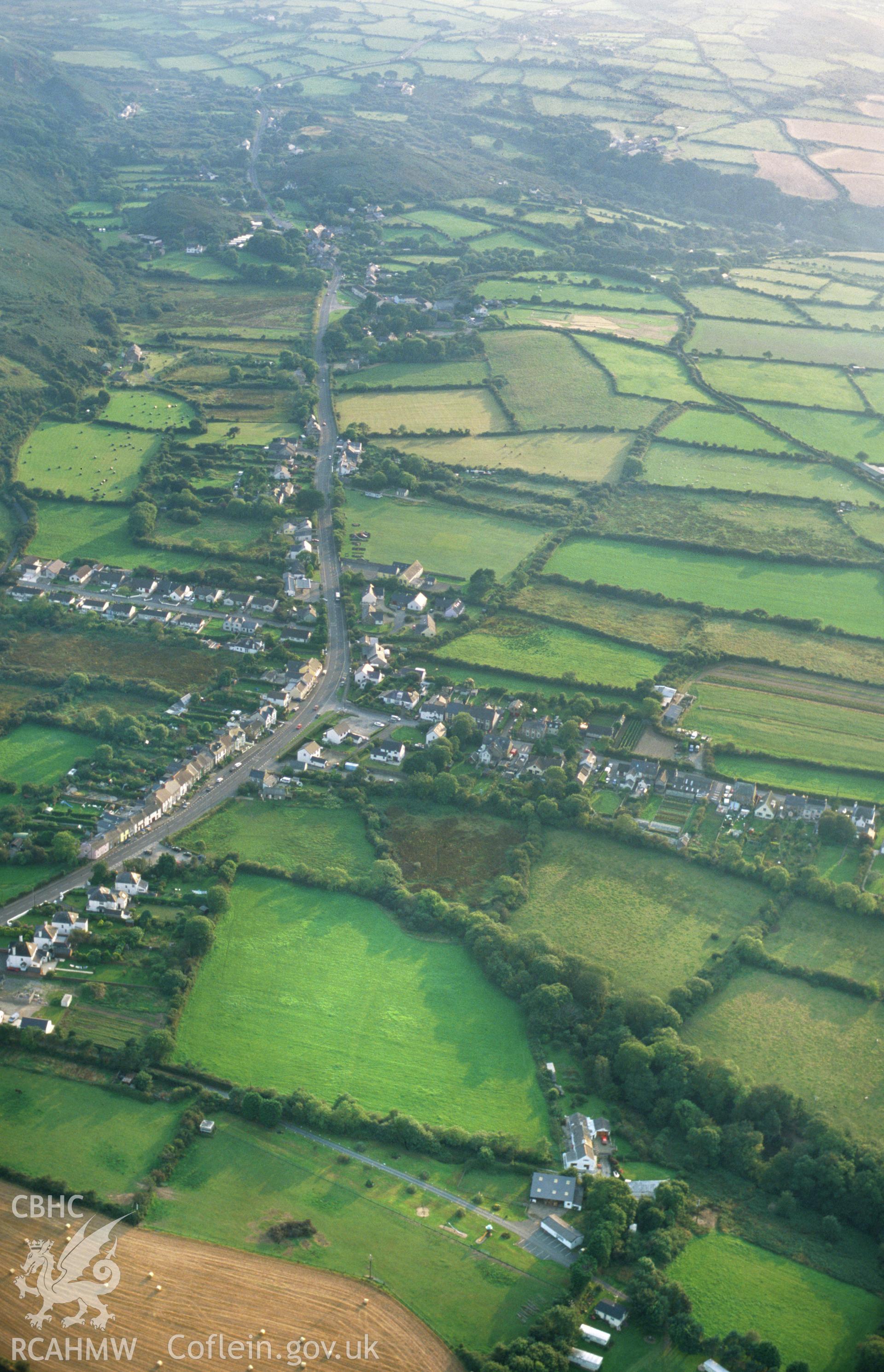 RCAHMW colour oblique aerial photograph of Dinas Cross village, from east. Taken by Toby Driver on 02/09/2002