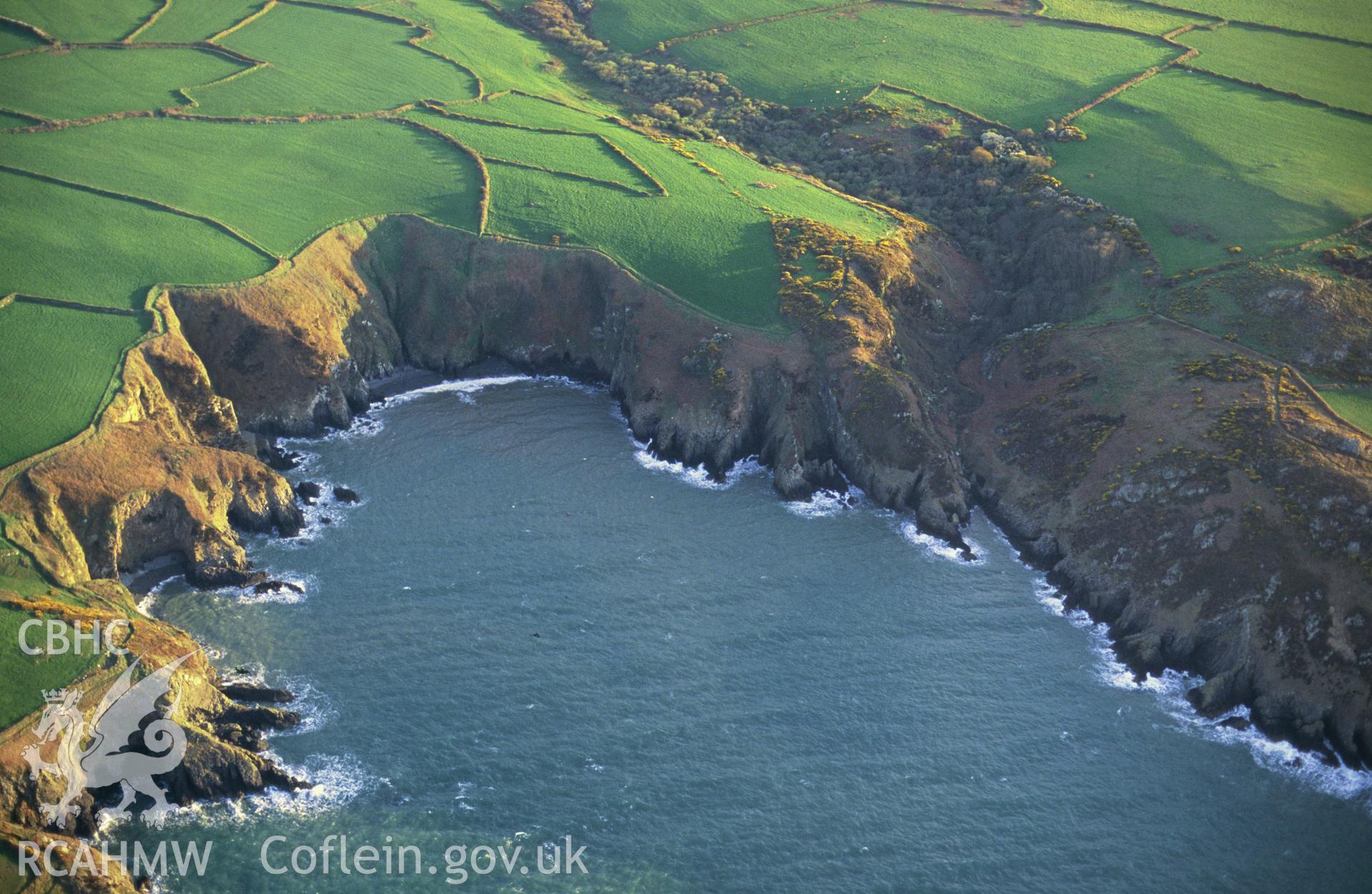 RCAHMW colour slide oblique aerial photograph of Carregwasted Bay, Pencaer, taken by C.R.Musson on the 28/04/1996