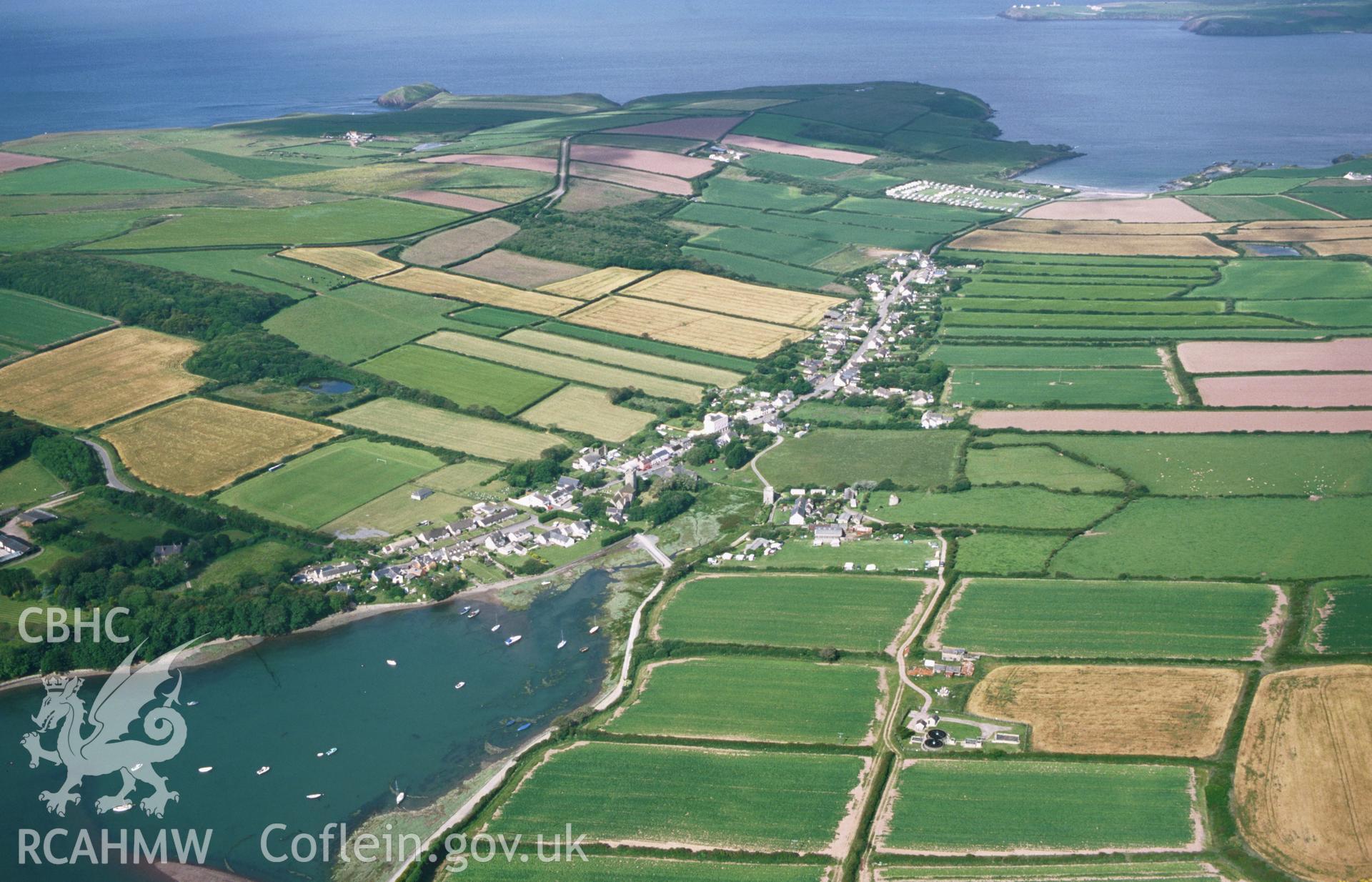 RCAHMW colour oblique aerial photograph of Angle, village and field system, from east. Taken by Toby Driver on 28/06/2002