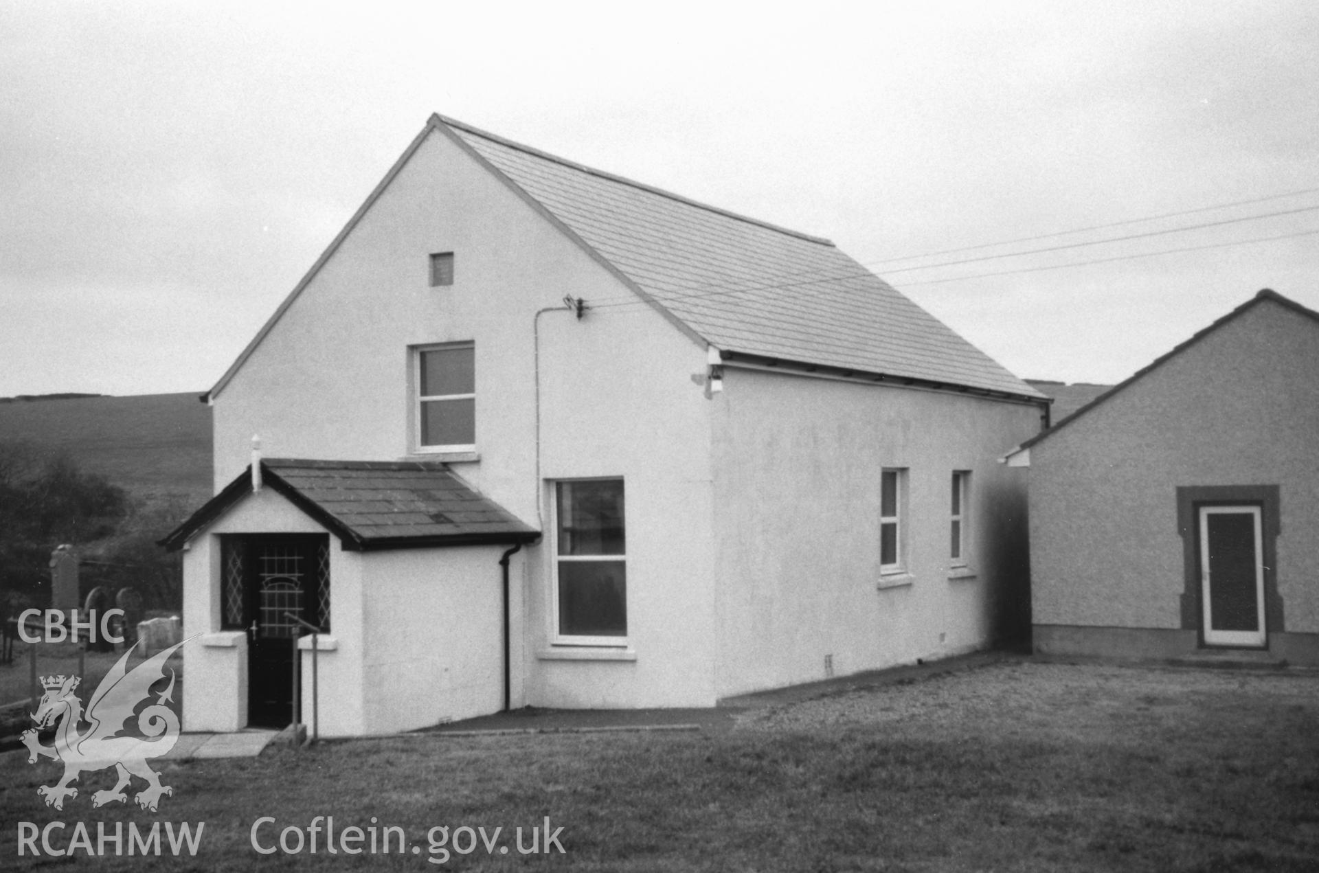 Digital copy of a black and white photograph showing an exterior view of Sutton English Baptist Chapel, taken by Robert Scourfield, 1996.