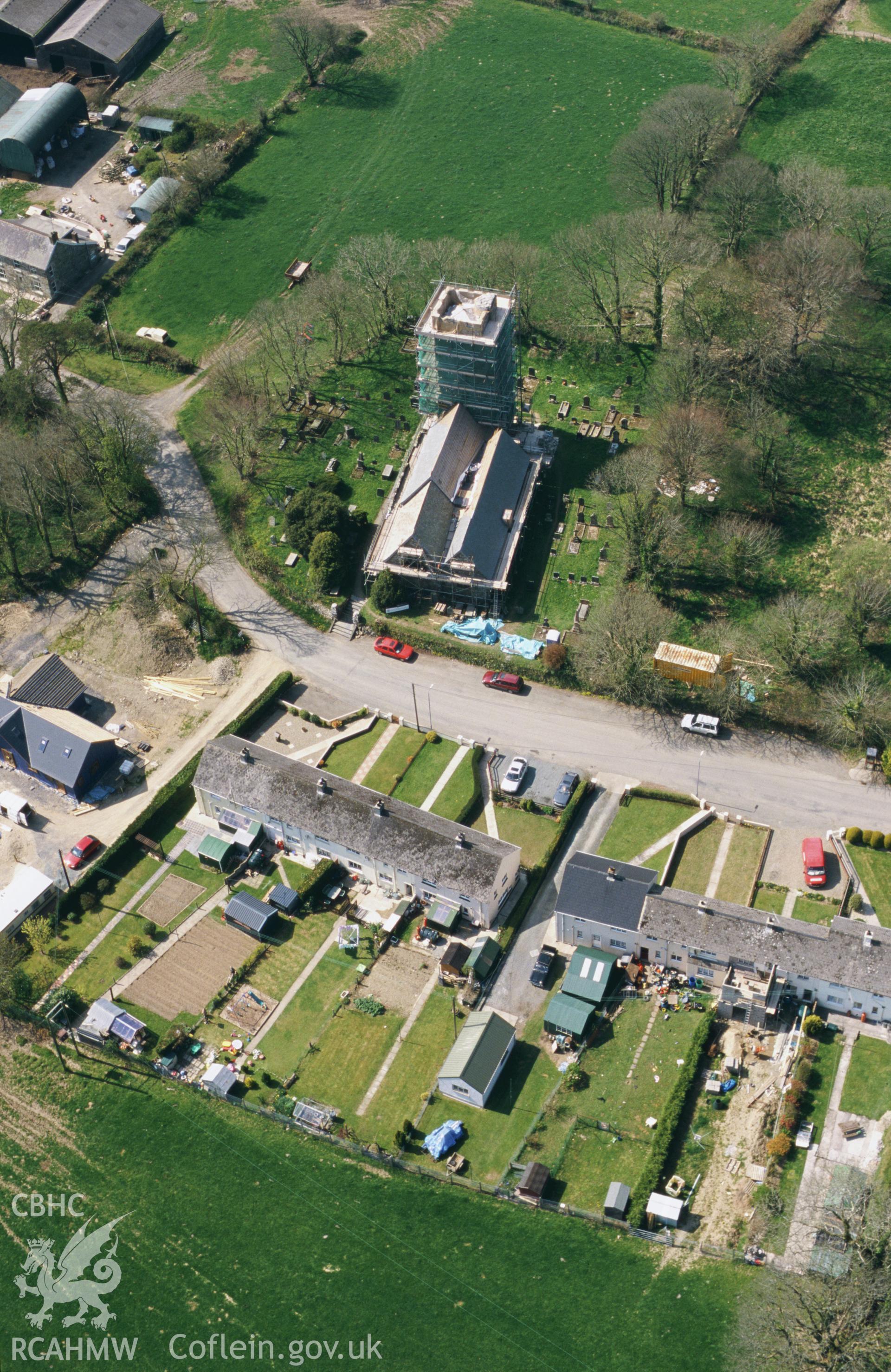 RCAHMW colour oblique aerial photograph of St Nicolas' Church, New Moat, with scaffolding. Taken by Toby Driver on 10/04/2003