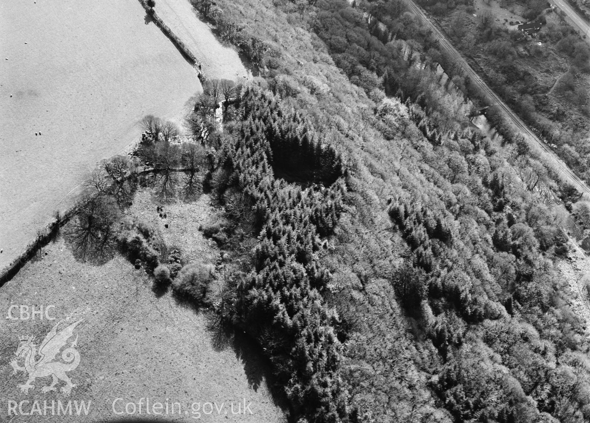 RCAHMW black and white oblique aerial photograph of Little Treffgarne Camp, taken by C R Musson, 27/02/1996.