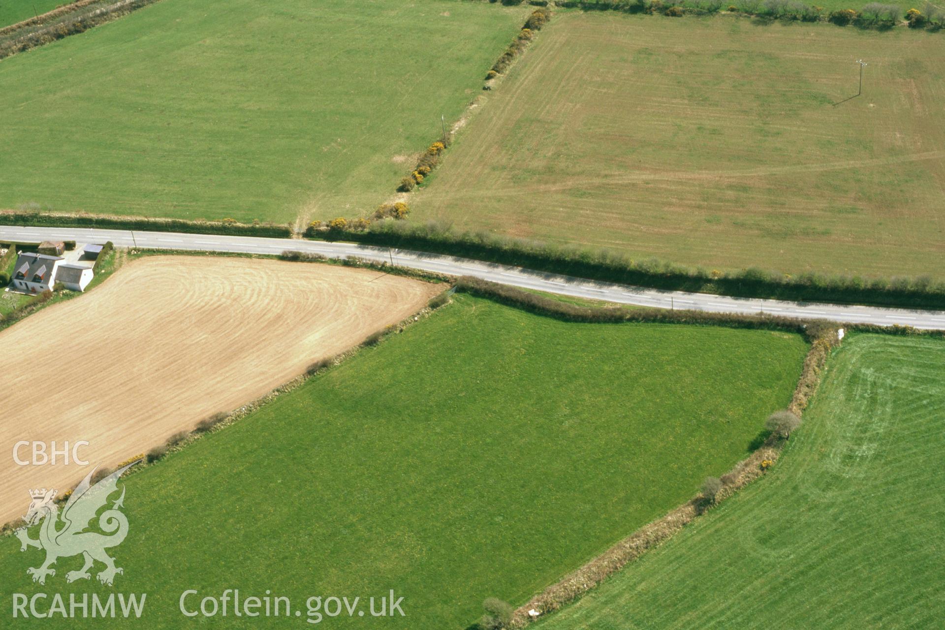 RCAHMW colour oblique aerial photograph of Tufton Castle, enclosure, with part of enclosure ploughed. Taken by Toby Driver on 10/04/2003