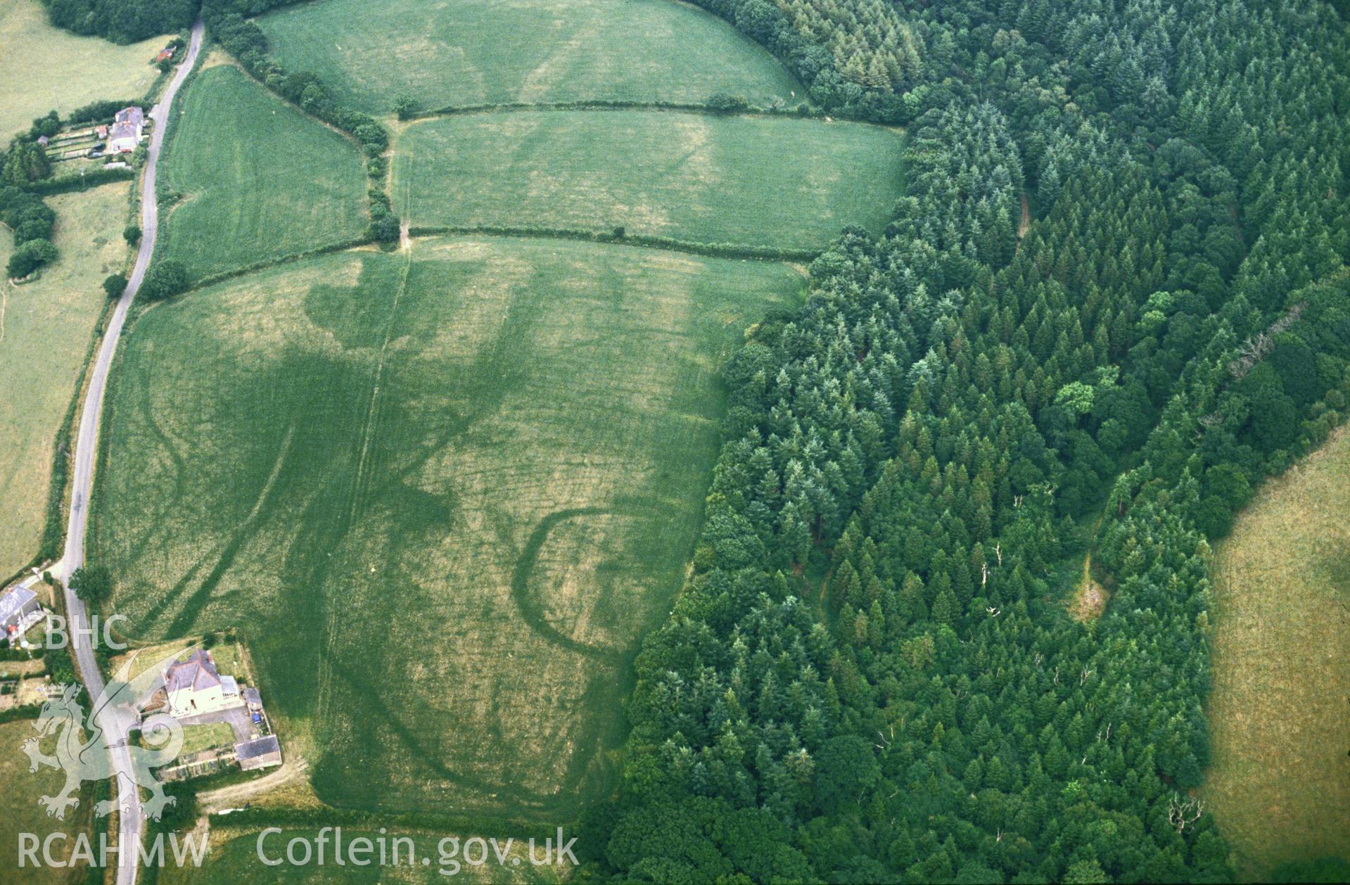 Slide of RCAHMW colour oblique aerial photograph of Bodringallt Enclosure, Llawhaden, taken by C.R. Musson, 1989.