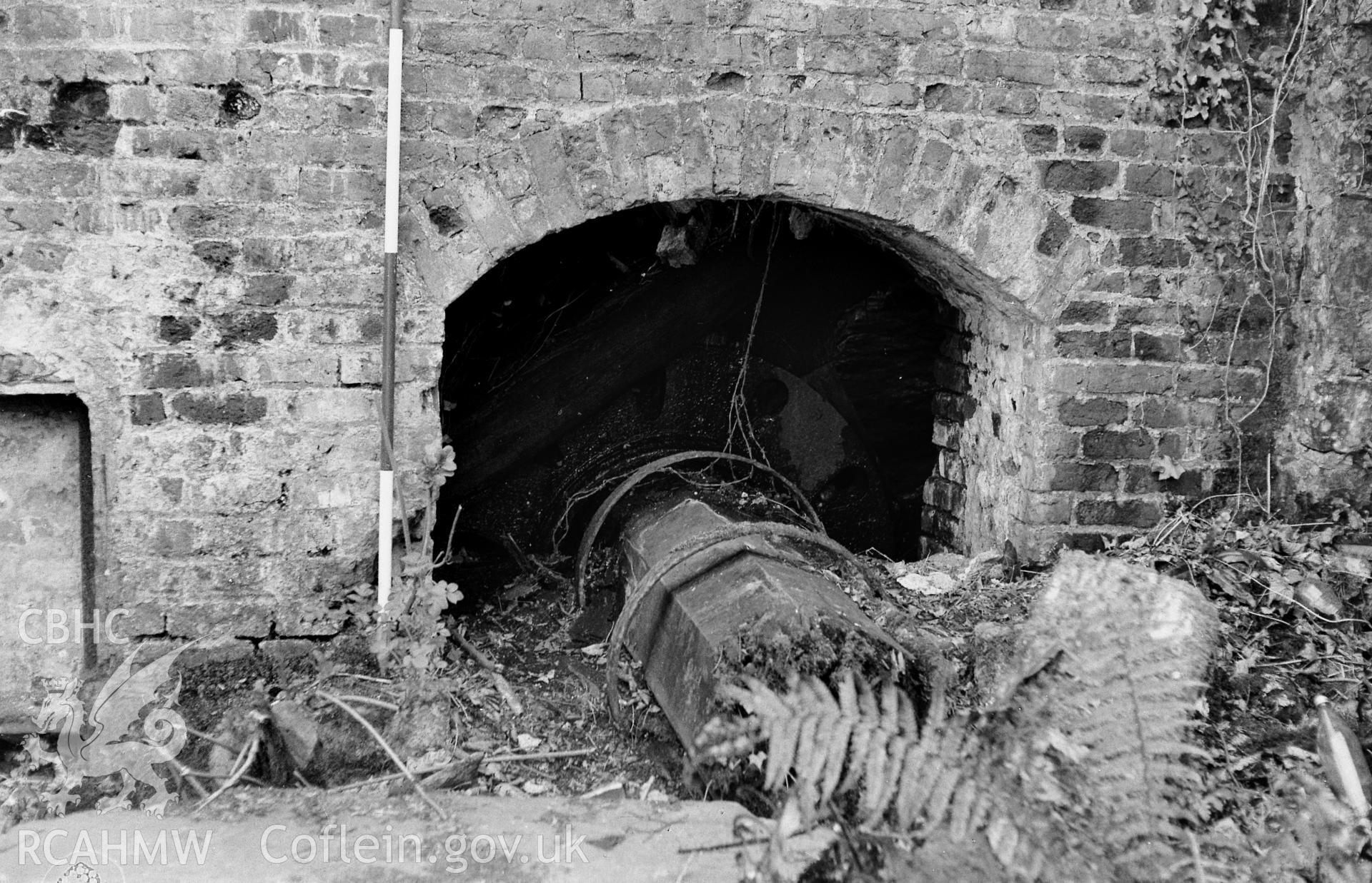 Exterior view showing wheel shaft protruding from the interior of the mill.