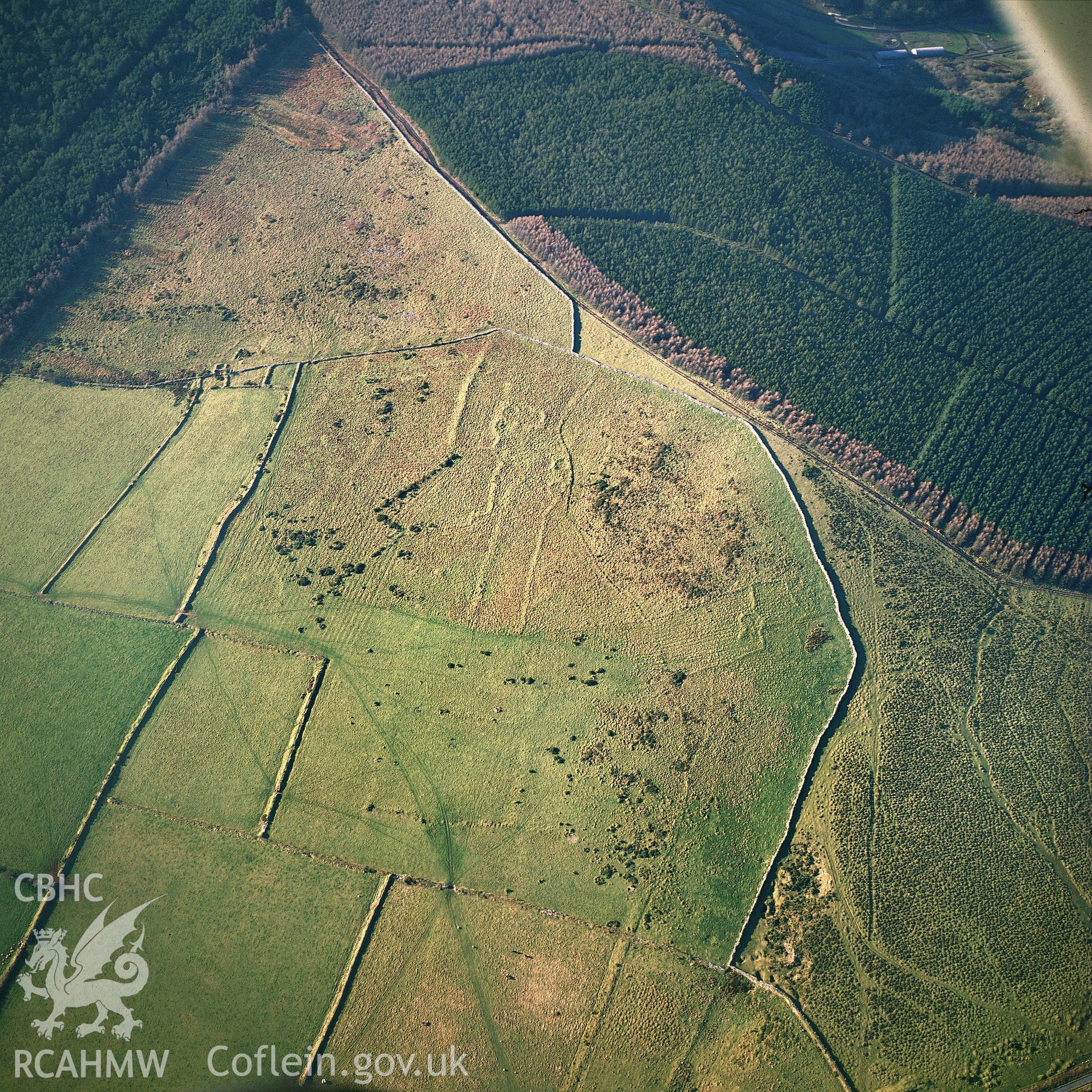 RCAHMW colour oblique aerial photograph of Fagwr-fran, settlement features & field system, taken by C R Musson, 1990.