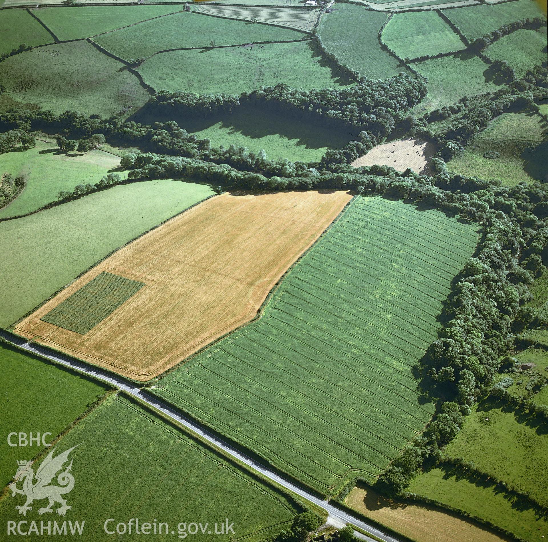 RCAHMW colour oblique aerial photograph of two circulinear enclosures near Holloway, Maenclochog, taken by CR Musson, 1990