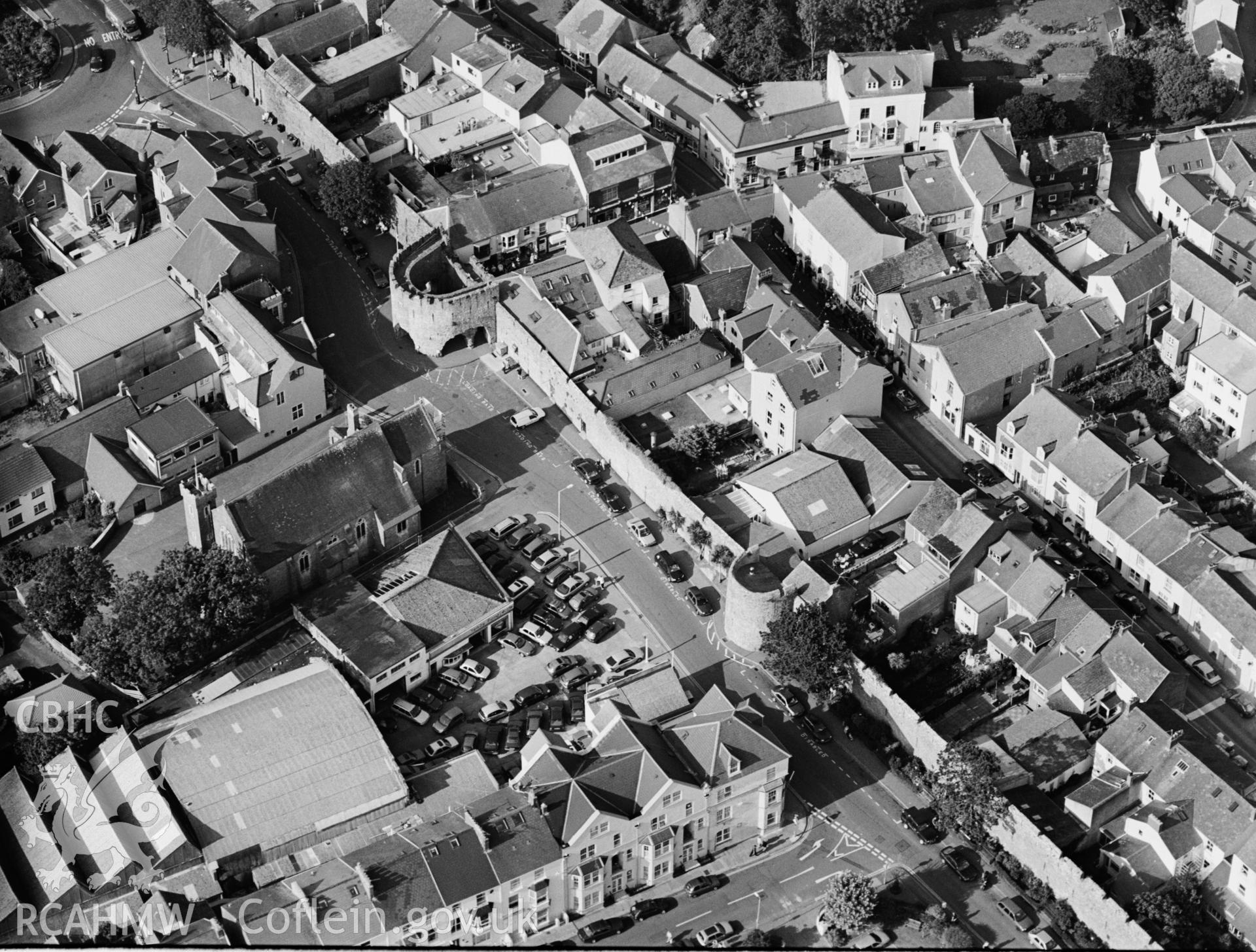 RCAHMW black and white oblique aerial photograph of Tenby town walls, and town centre. Taken by Toby Driver on 02/09/2002