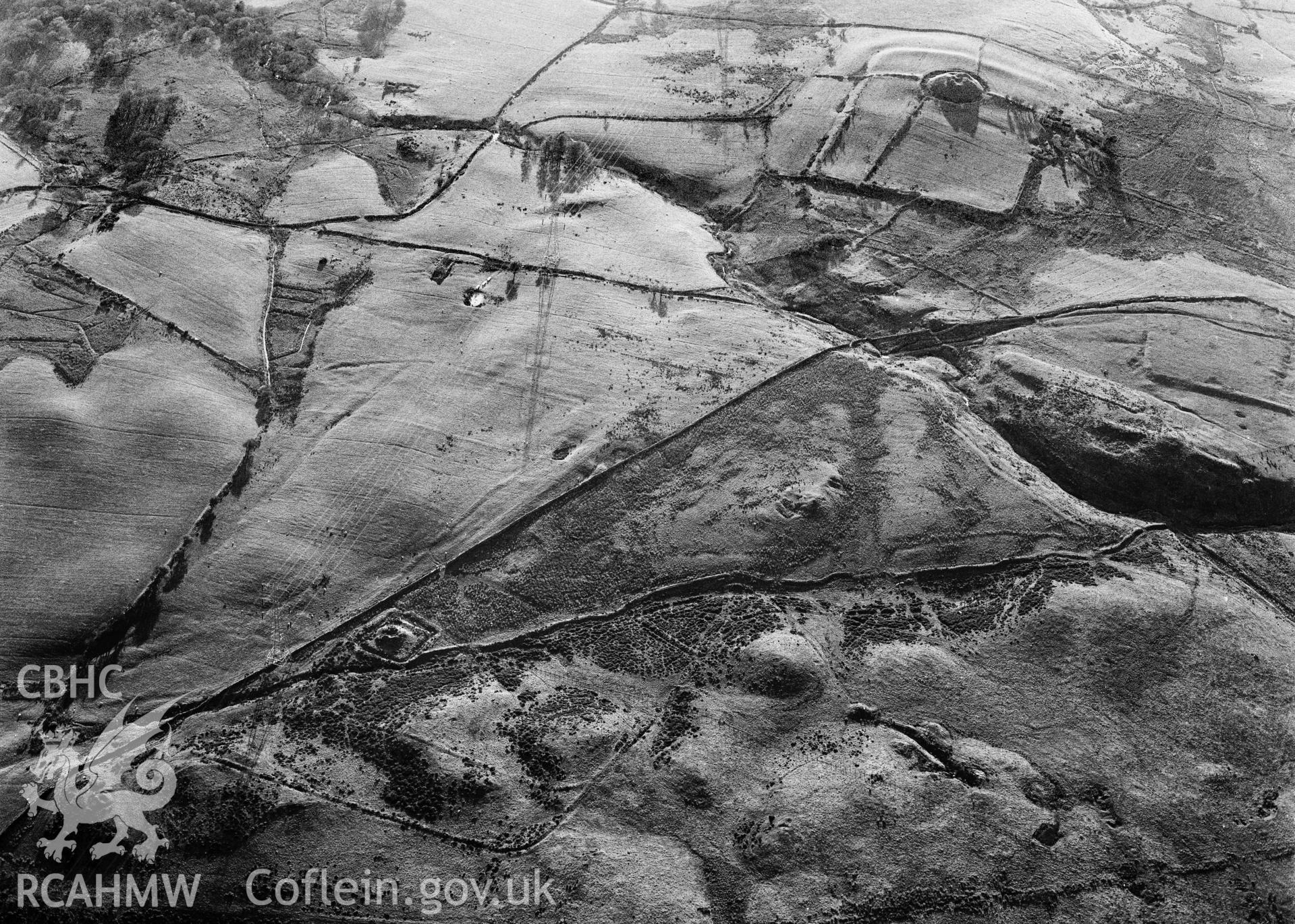 RCAHMW black and white oblique aerial photograph of Tomen-y-mur East Roman camps, taken by C R Musson, 06/05/1996.