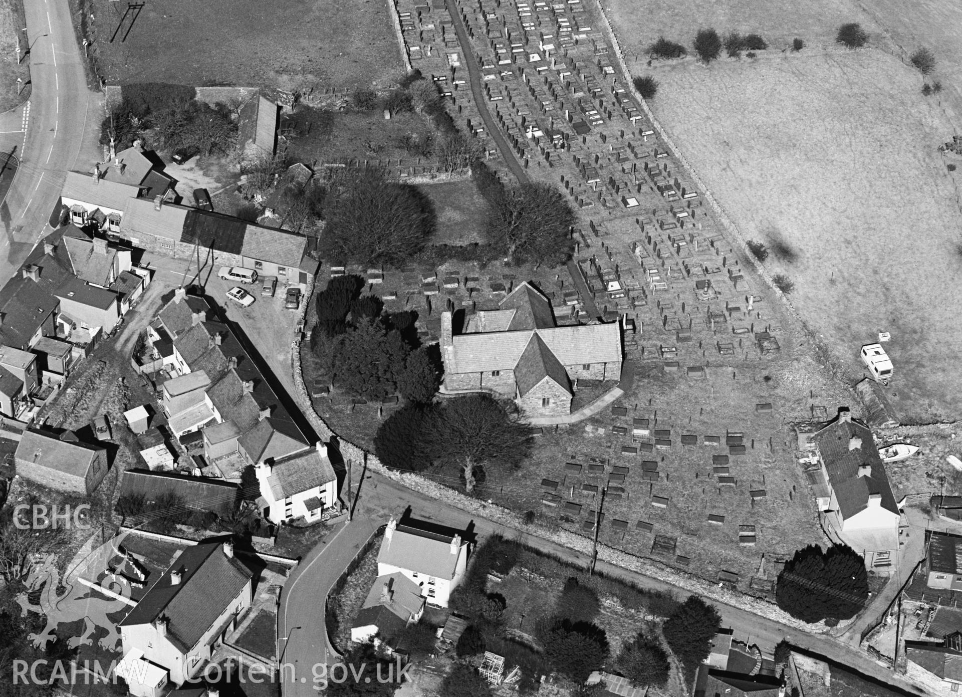 RCAHMW black and white oblique aerial photograph of St Aelhaerarns Church, taken by C R Musson, 29/03/1996.