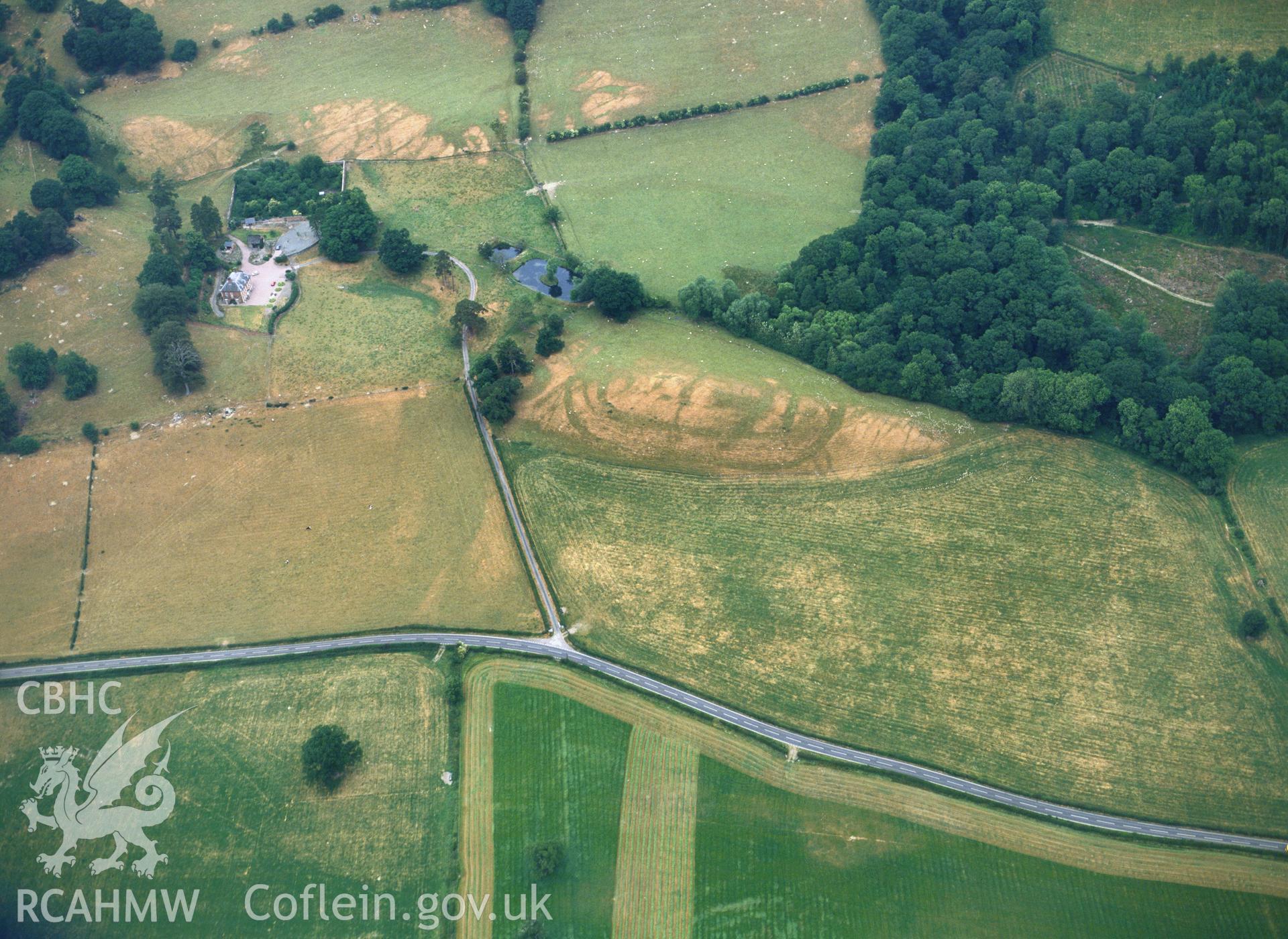 RCAHMW colour oblique aerial photograph of Plas Uchaf Enclosuret, taken by C R Musson, 1989.