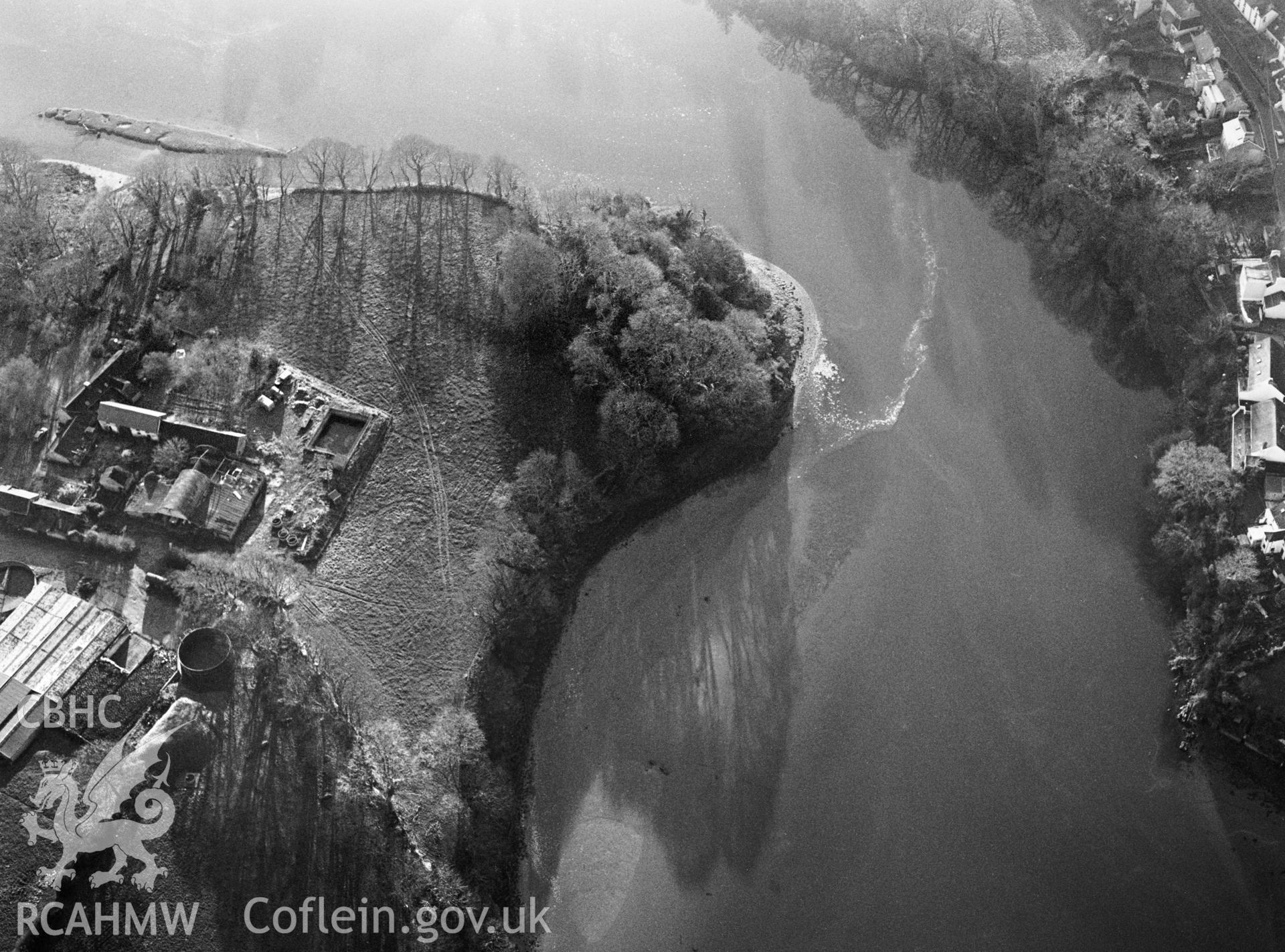 RCAHMW black and white oblique aerial photograph of Cardigan Old Castle, motte (wooded). Taken by Toby Driver on 13/12/2002