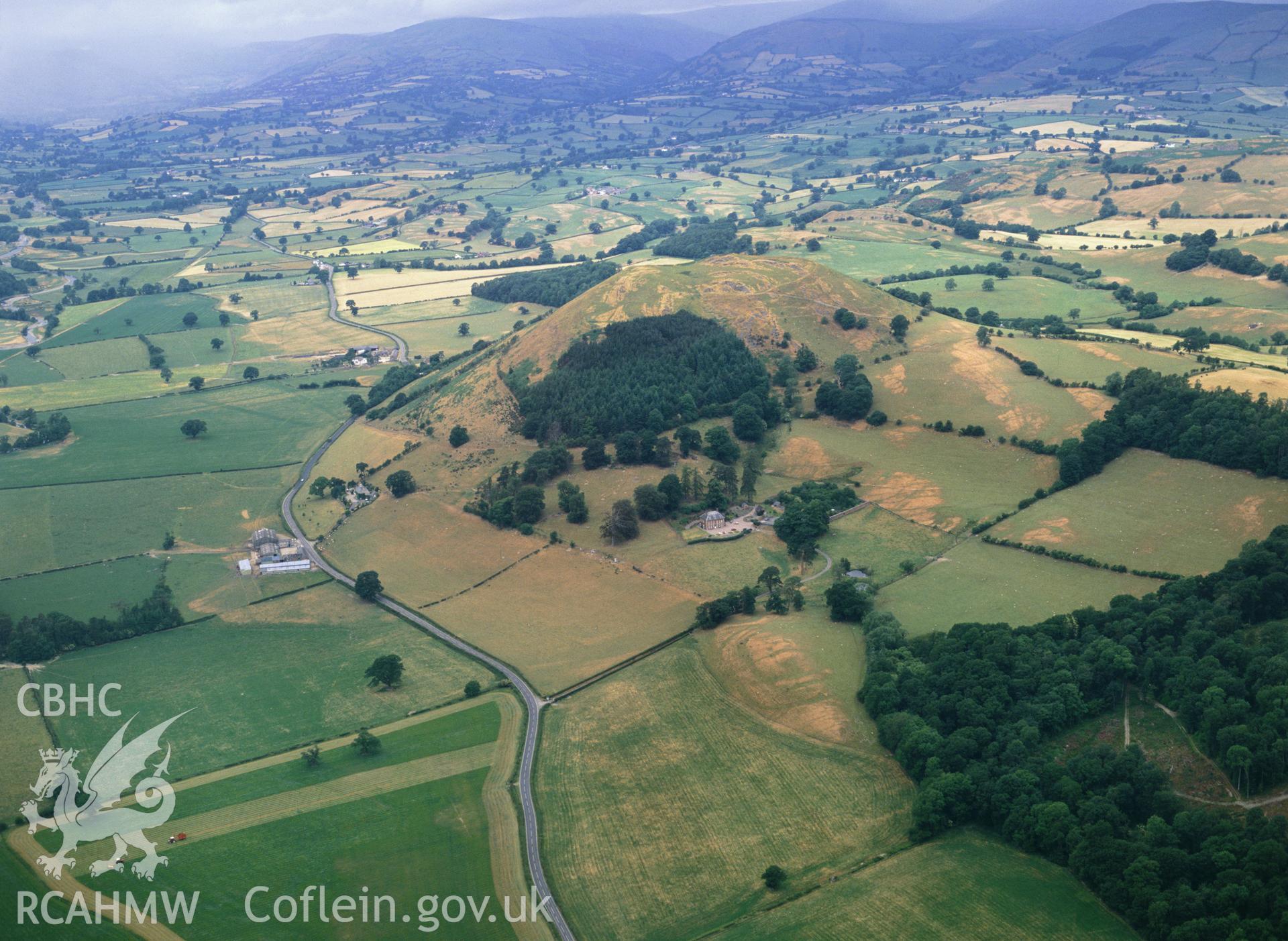 RCAHMW colour oblique aerial photograph of Llwyn Bryn Dinas Hillfort, taken by C R Musson, 1989.