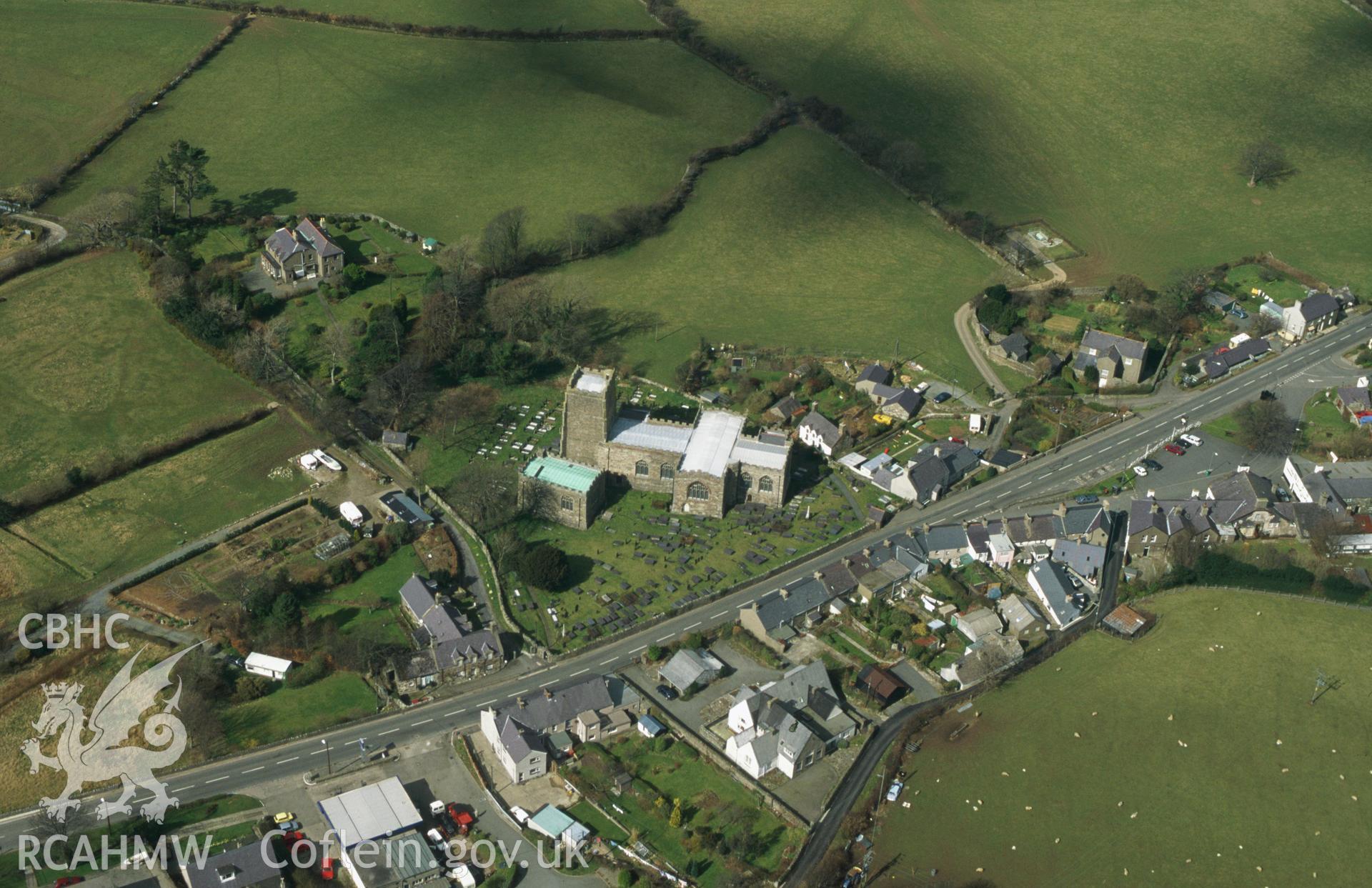 RCAHMW colour slide oblique aerial photograph of St Beuno's Church, Clynnog Fawr, Clynnog, taken by C.R.Musson on the 29/03/1996