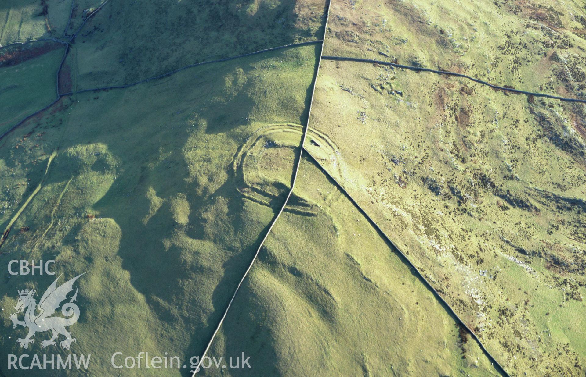 Slide of RCAHMW colour oblique aerial photograph of Moel Goedog Hillfort, Harlech, taken by T.G. Driver, 2005.