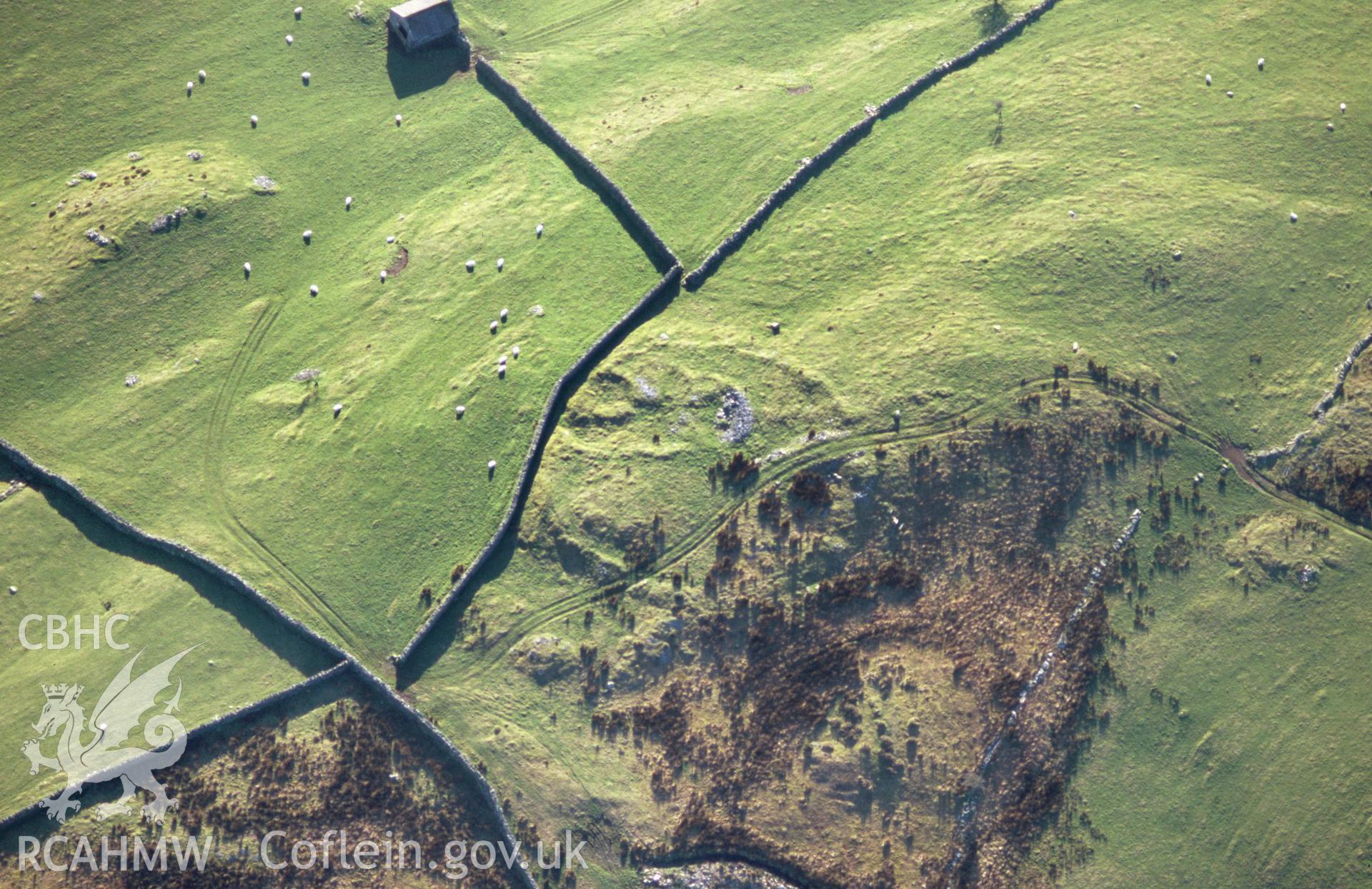 Slide of RCAHMW colour oblique aerial photograph of Yr Onen Hut Group, Talsarnau, taken by T.G. Driver, 2005.