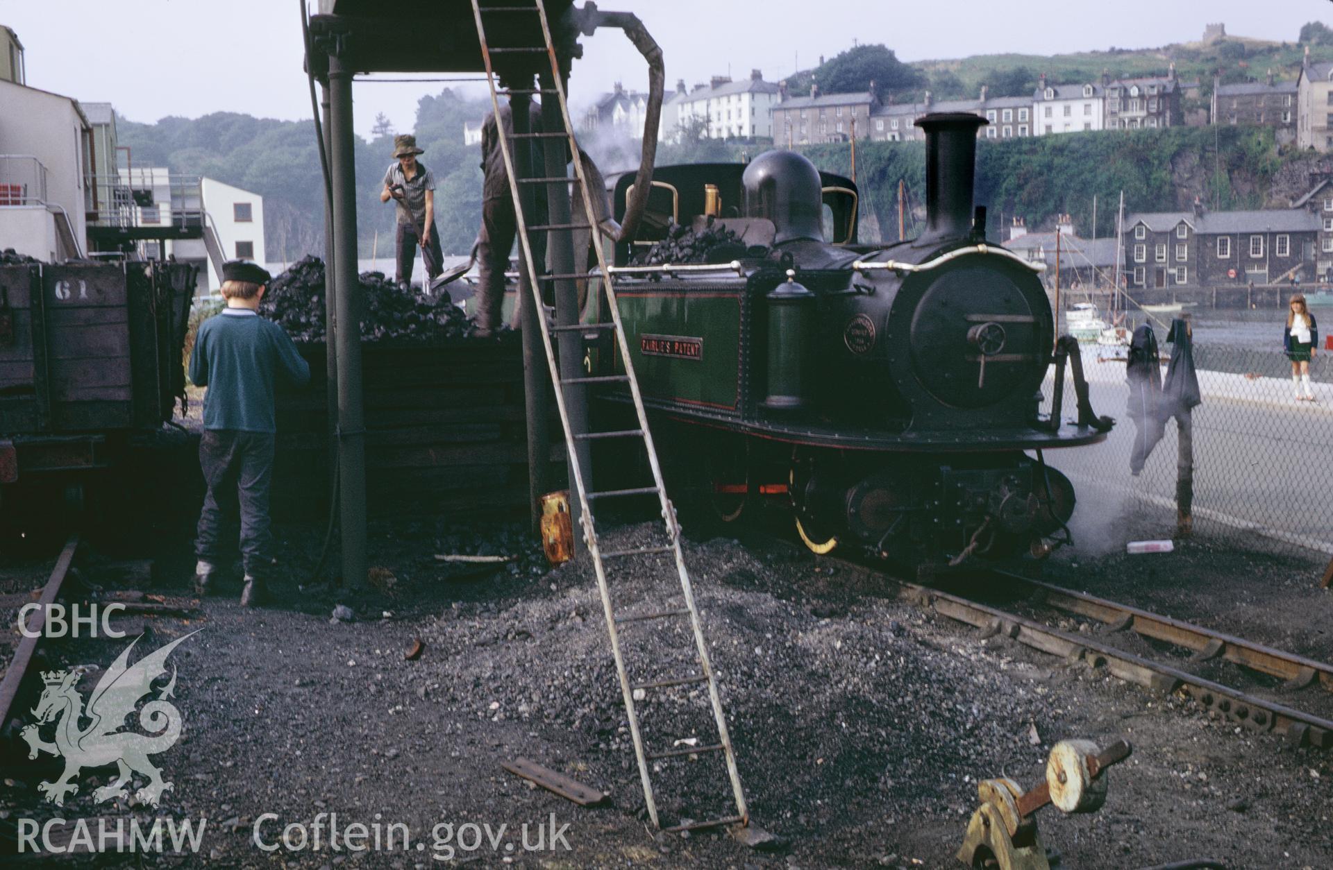 35mm colour slide showing steam locomotive taking on water at Portmadog Station, Ffestiniog Railway,  Merionethshire - Caernarvonshire by Dylan Roberts, undated.