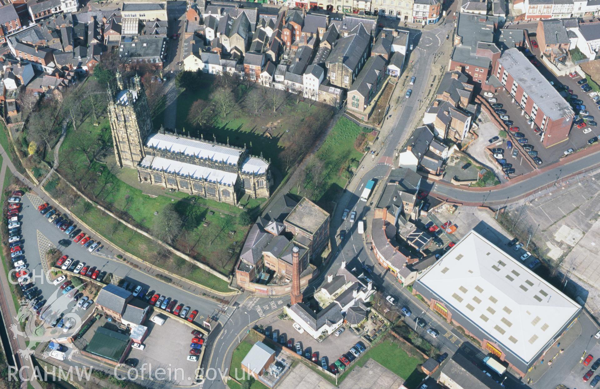 RCAHMW colour oblique aerial photograph of Wrexham, St Giles Church, and town centre. Taken by Toby Driver on 14/03/2003