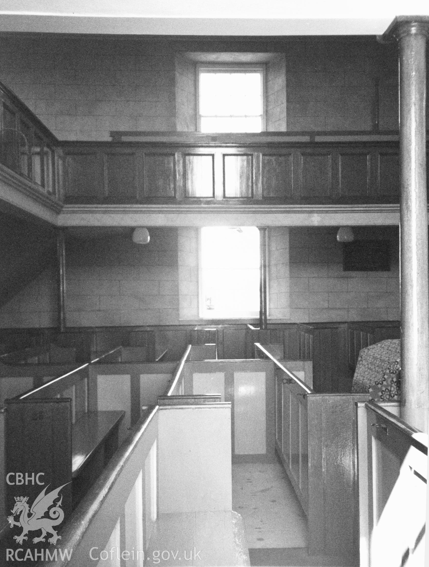 Digital copy of a black and white photograph showing an interior view of Penuel Welsh Baptist Chapel, Cemaes, taken by Robert Scourfield, c.1996.