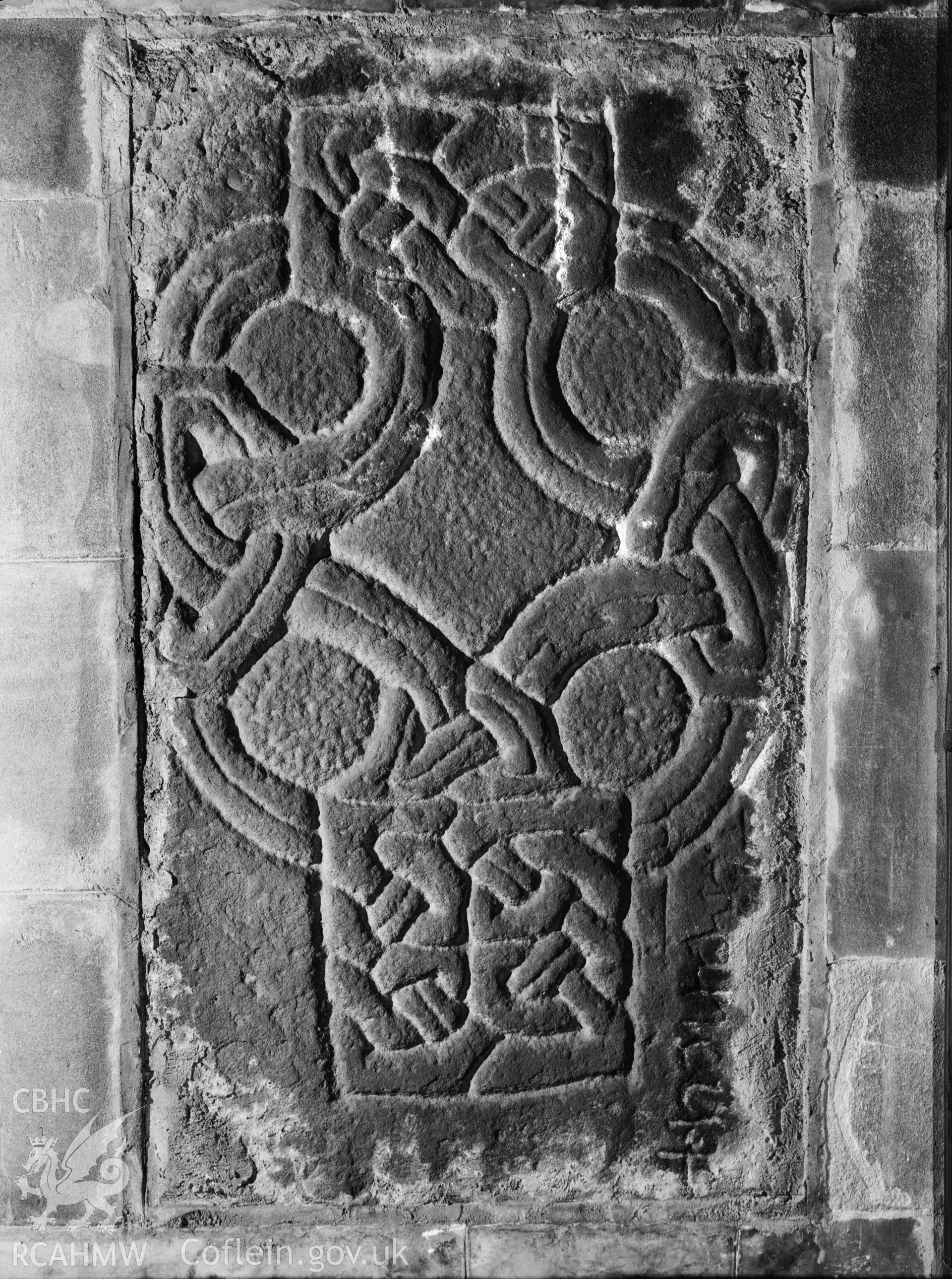 Black and white print of  the Brancu Stone, Baglan Church. Negative held. The inscription reads "+BRANCU.F[]”. The assumption is that the final letter is F = Fecit (Brancu made it).