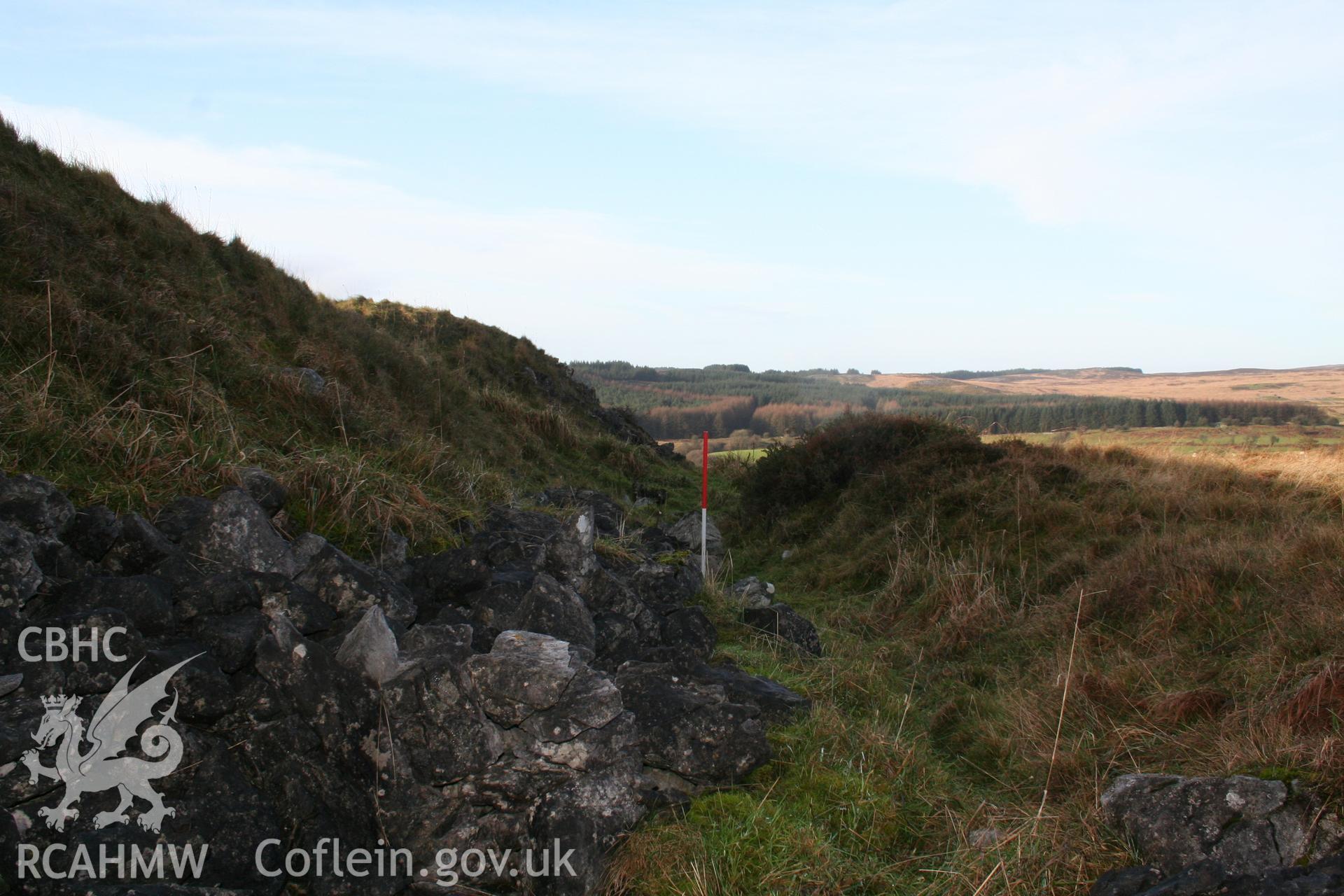 View along the northern ditch of the enclosure from the east; 1m scale.