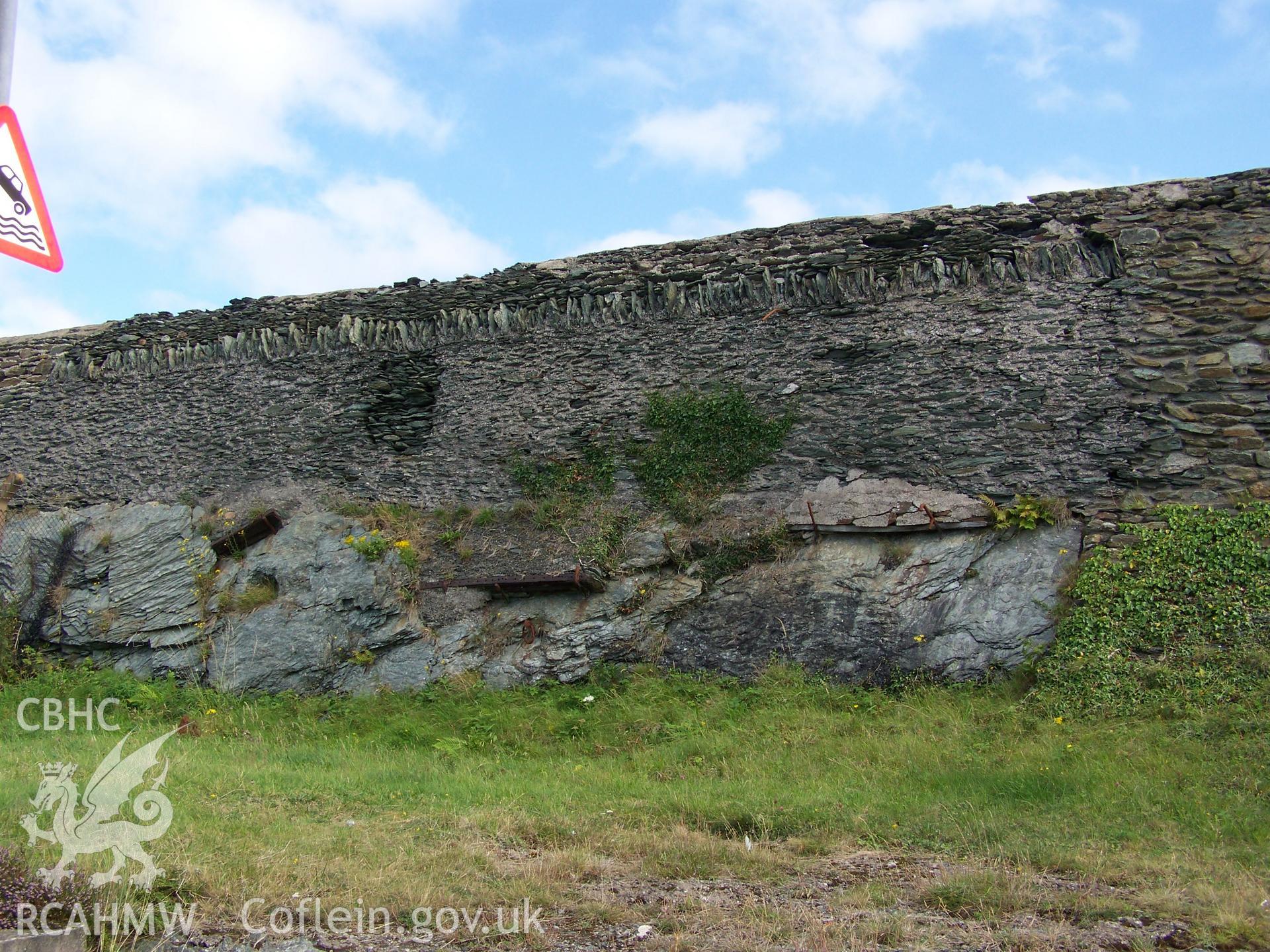 Northern face of the wall showing use of rocks outcropping as foundation and phases of rebuilding.