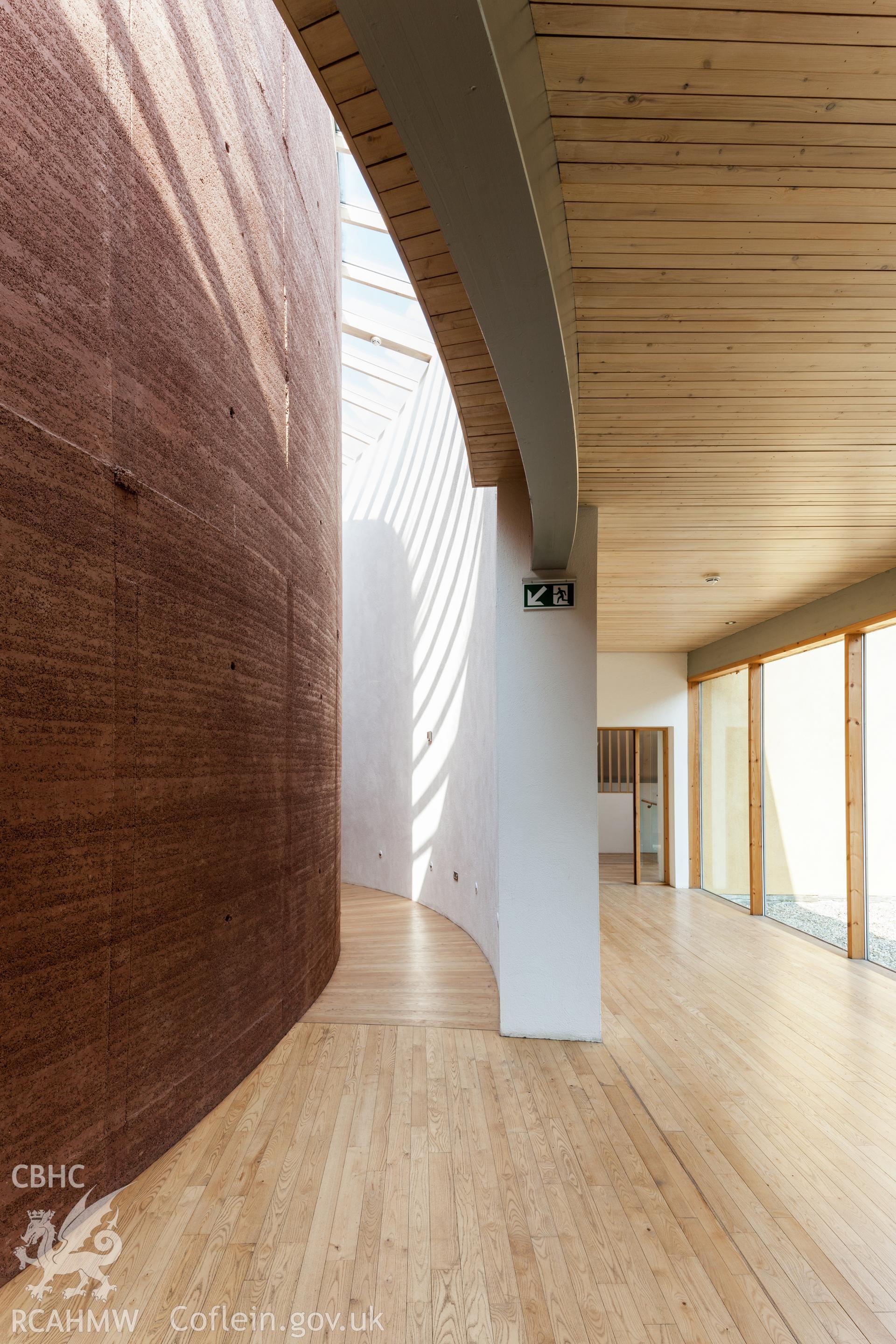 Interior view of rammed earth wall of lecture theatre.