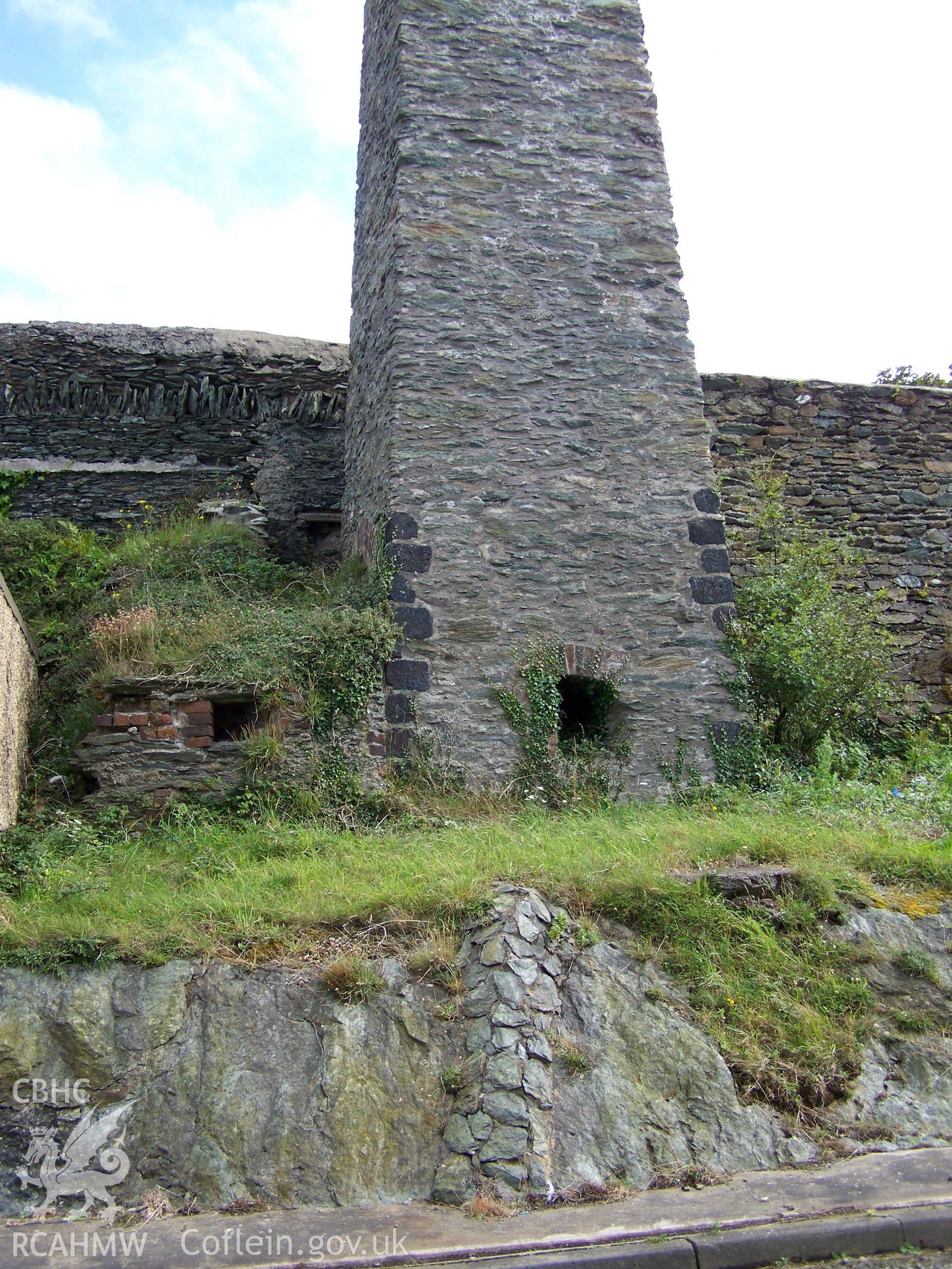 View of the base of the chimney showing the painted quoins and fire place.