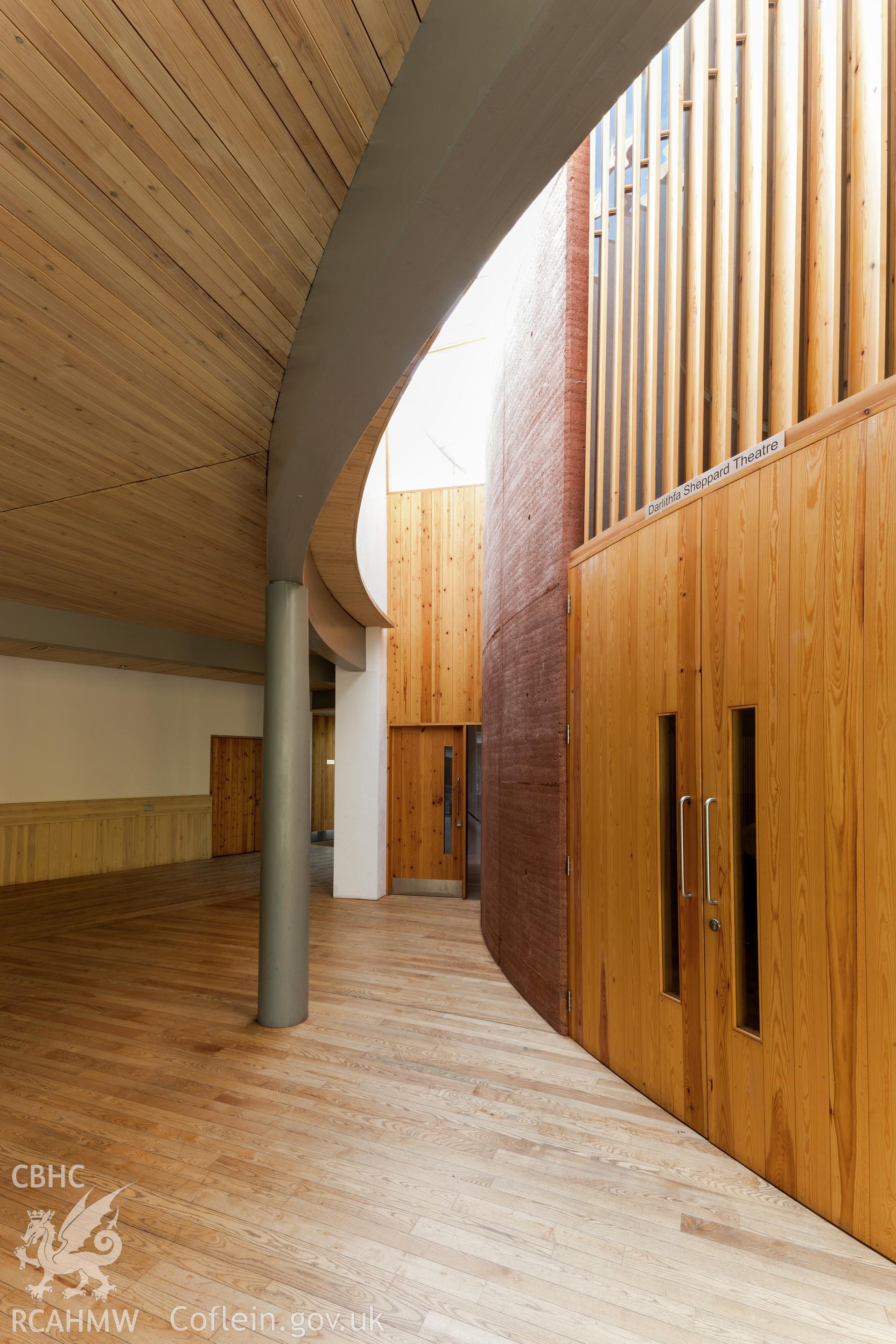 Interior view of rammed earth wall of lecture theatre.