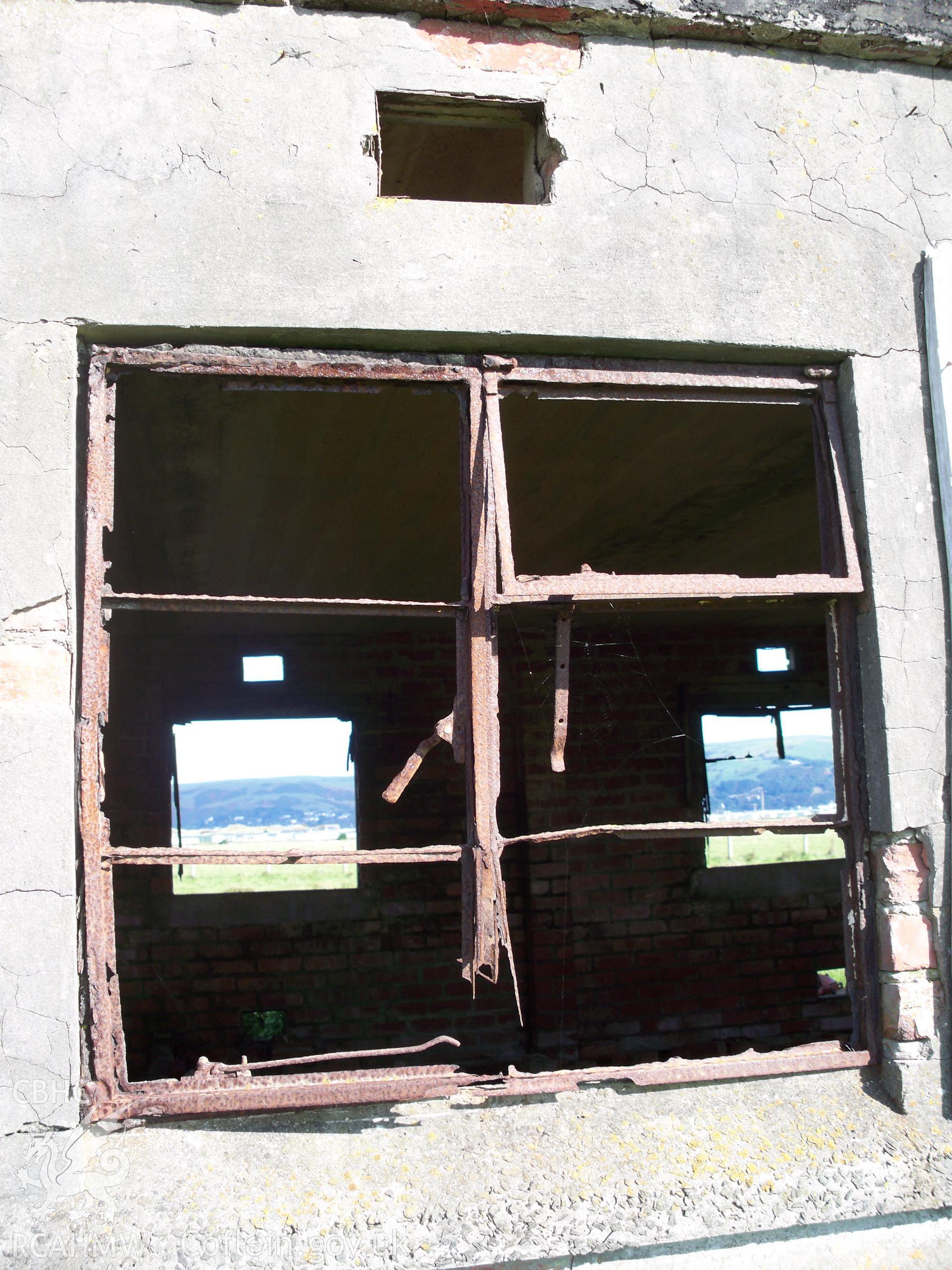 Window in southern elevation retaining metal framing (vent above)