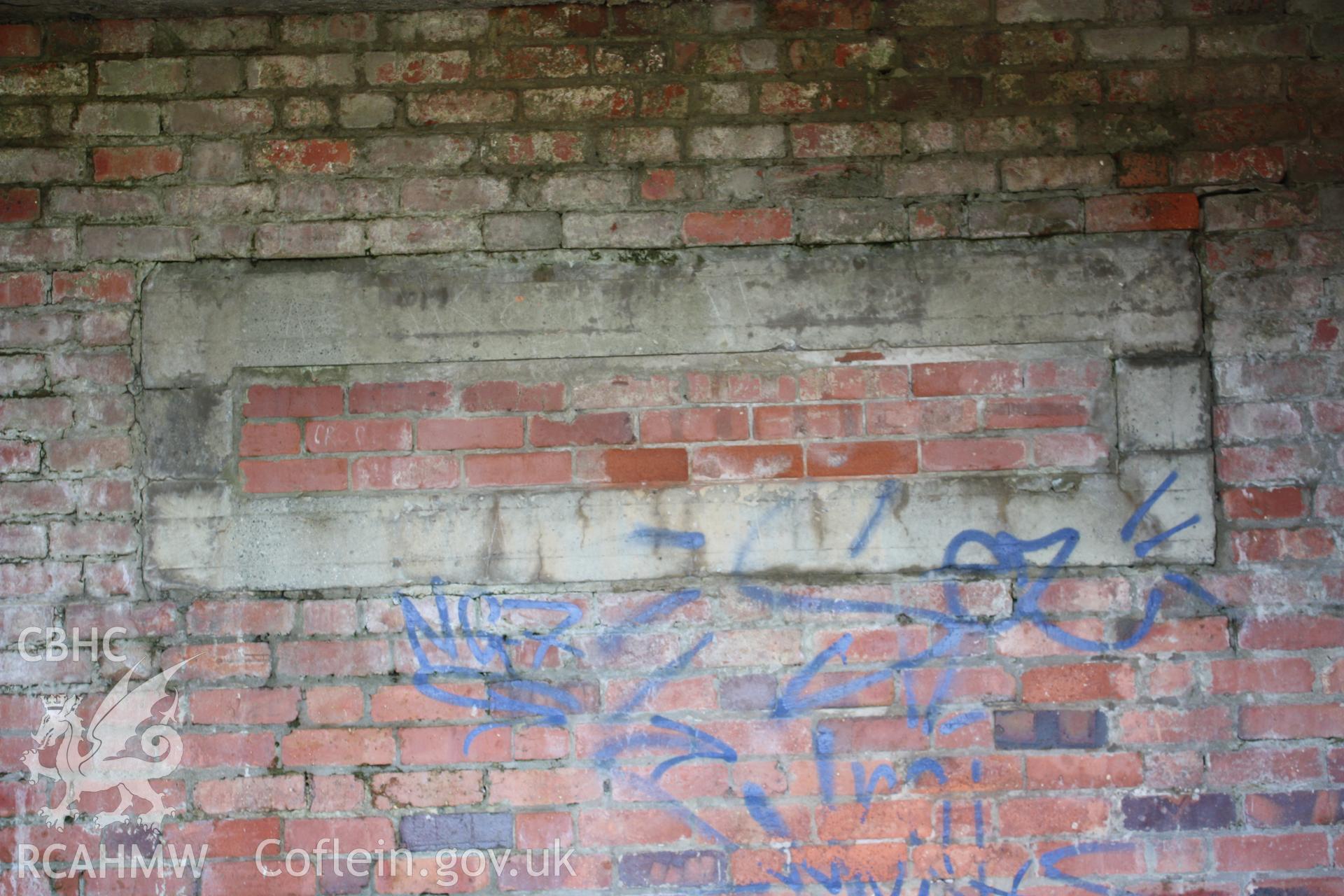 Interior of northern bay showing bricked up observation slit and grafitti.