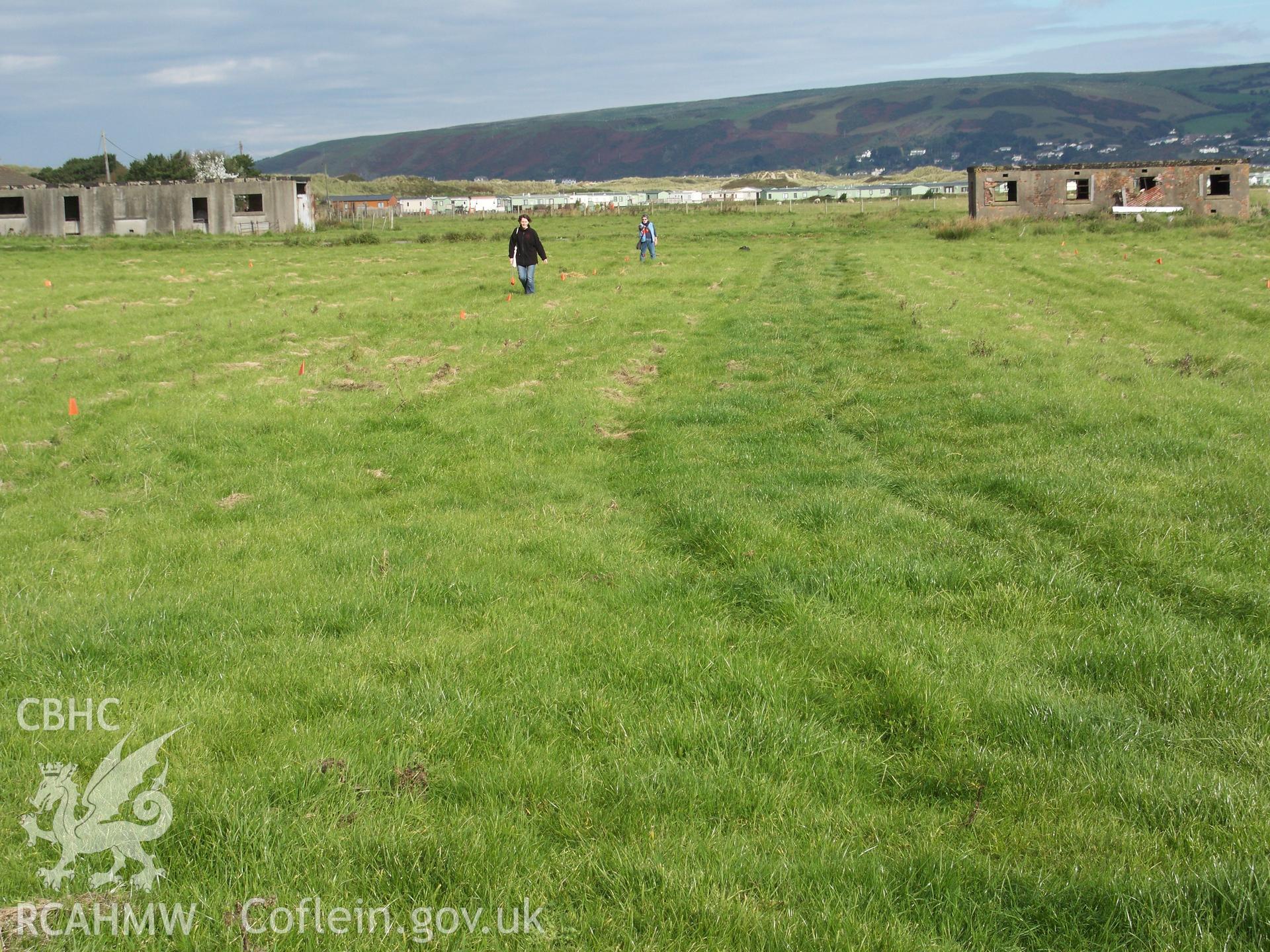 Alignment of axis of 12-hut complex being determined by RC staff and marked with survey flags