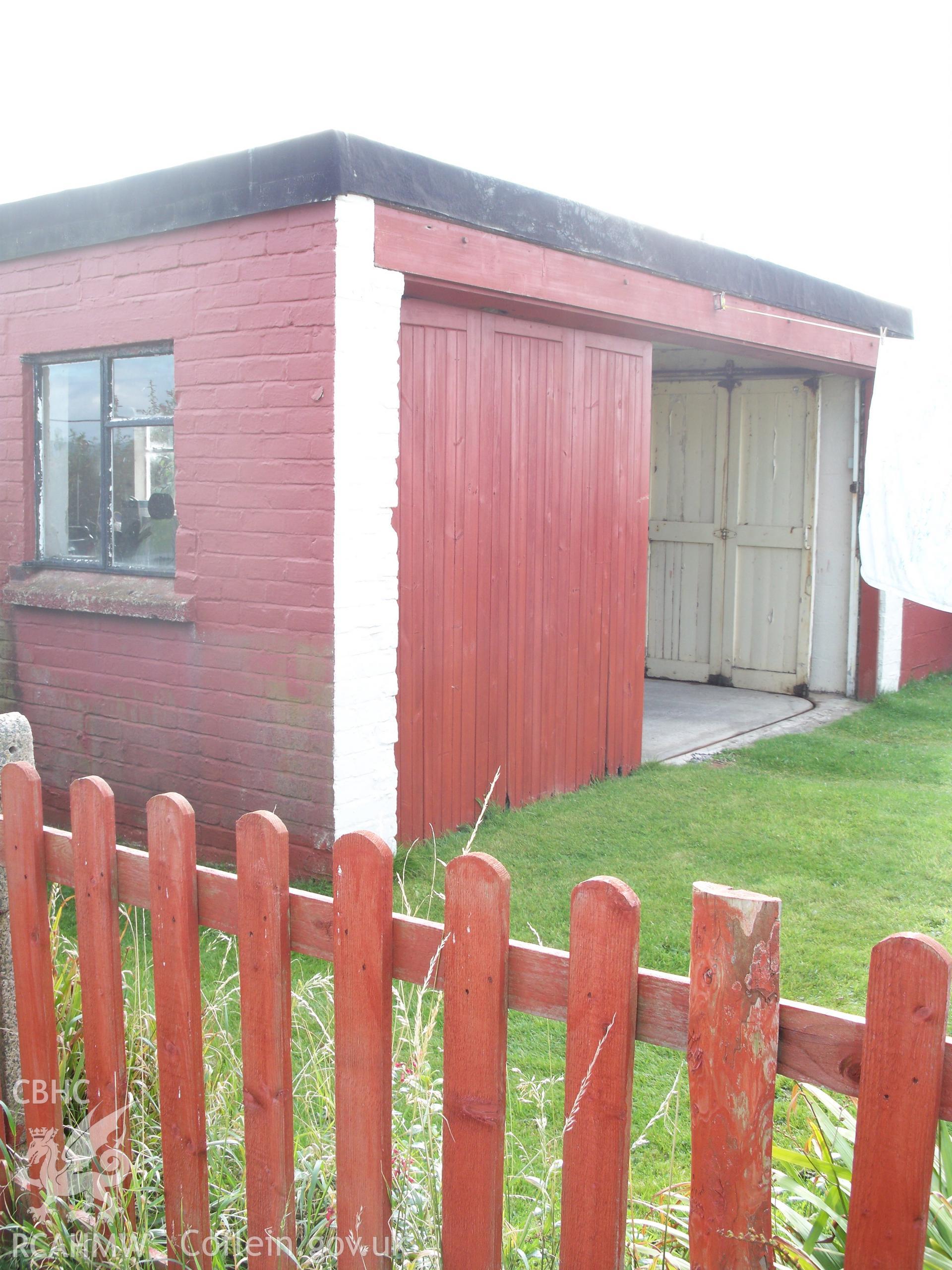 Western elevation with large opening door in sliding track