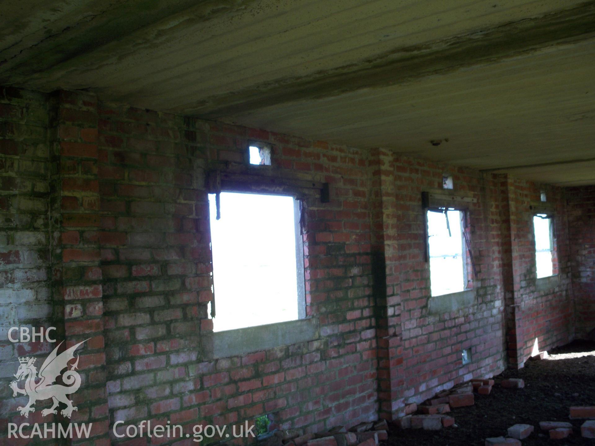 Interior of northern wall with windows, concrete sills, and vents over