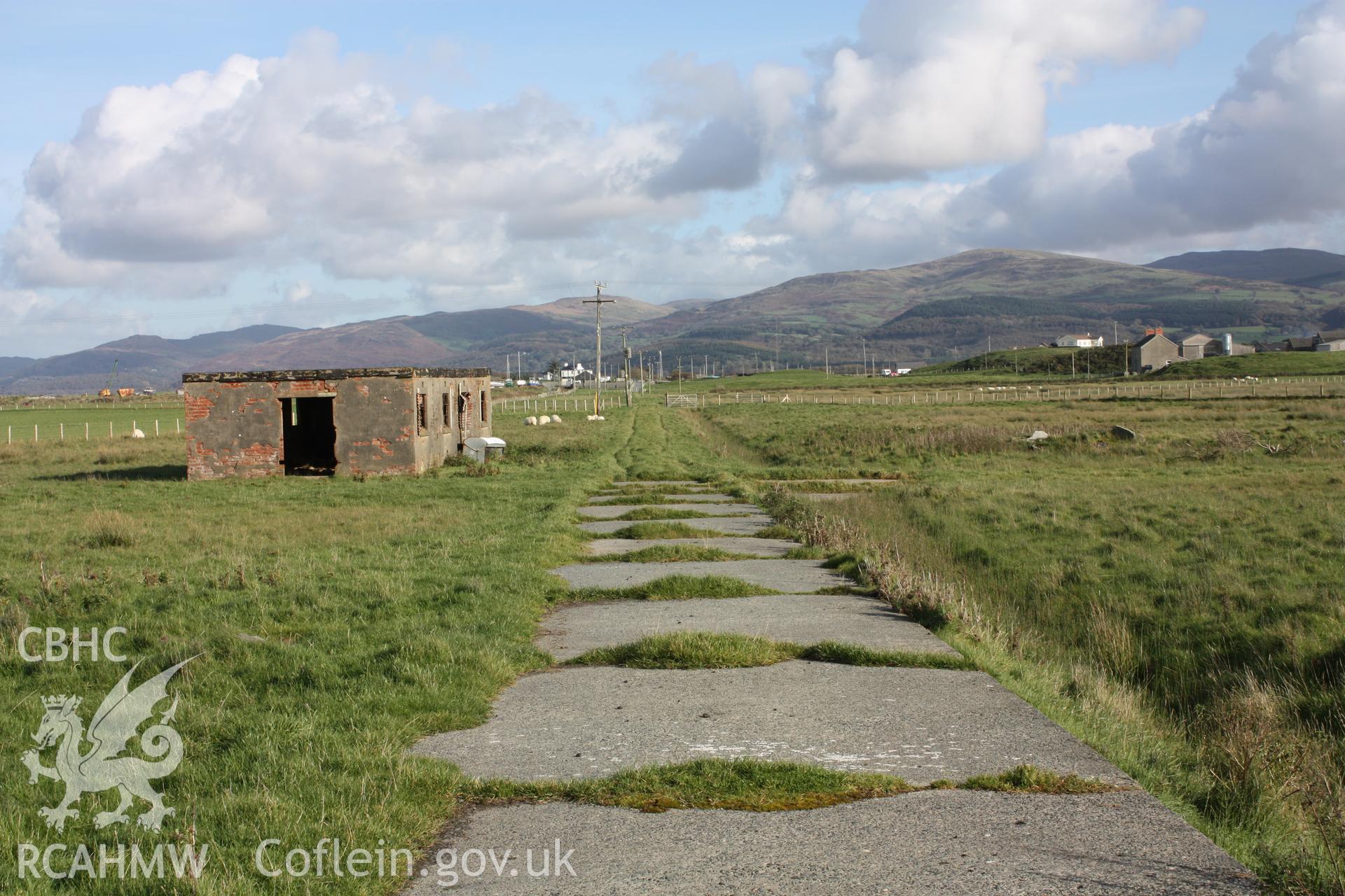 Military access road to main MOS EE camp looking eastwards with surviving camp building to left.